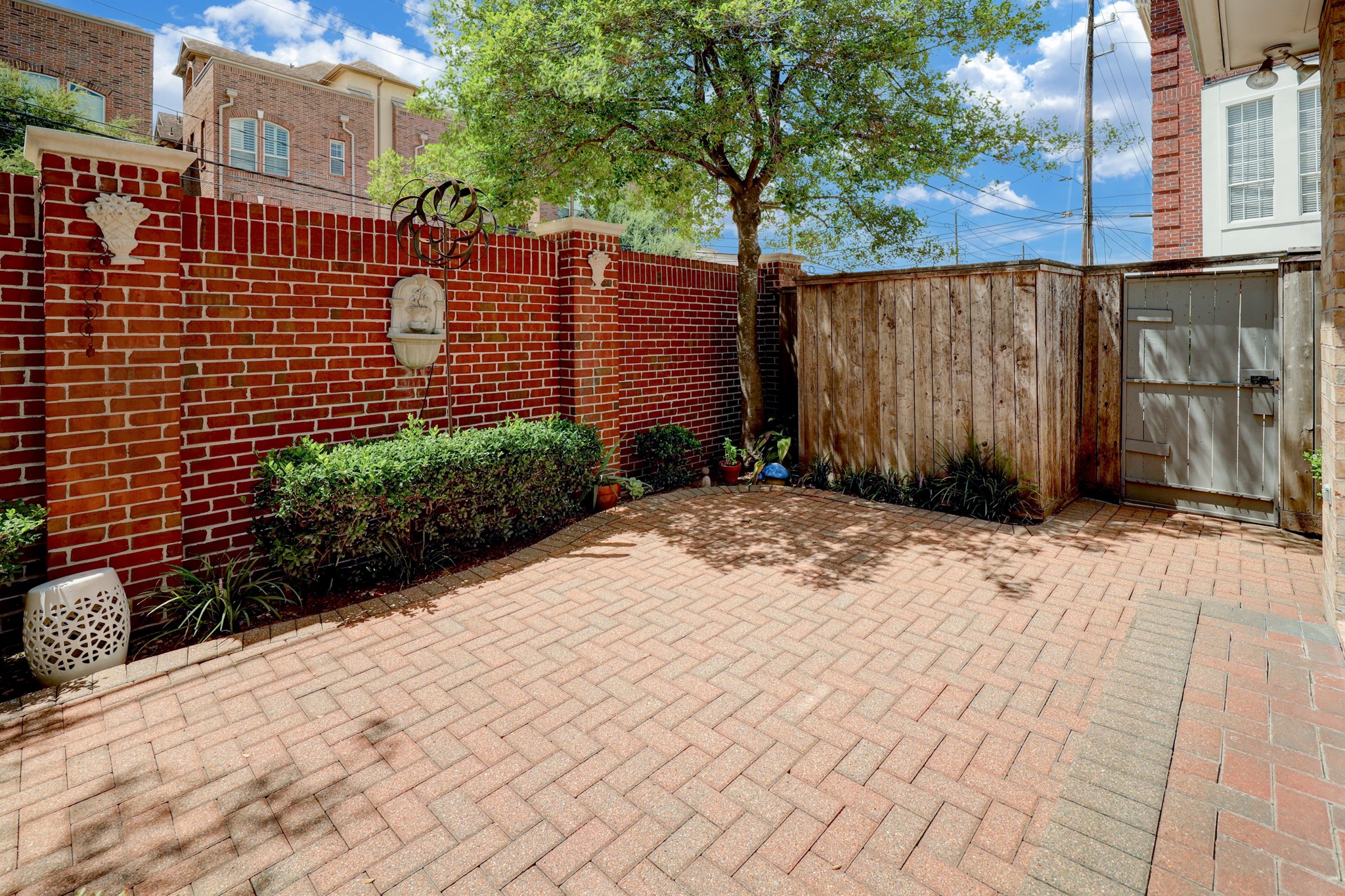 The rear wall of the patio is attractive red brick.