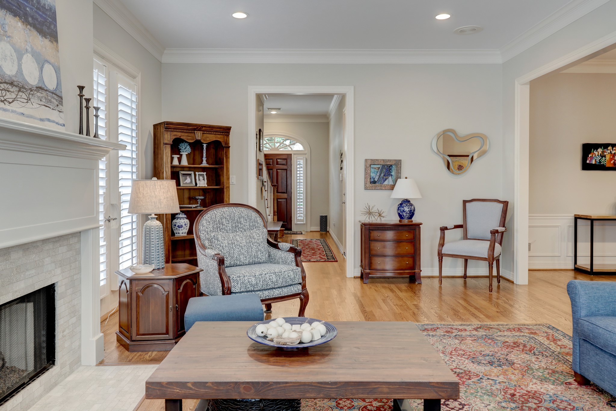 This view of the family room shows the foyer and entry. The powder room is conveniently tucked under the stairs of the entry hall.