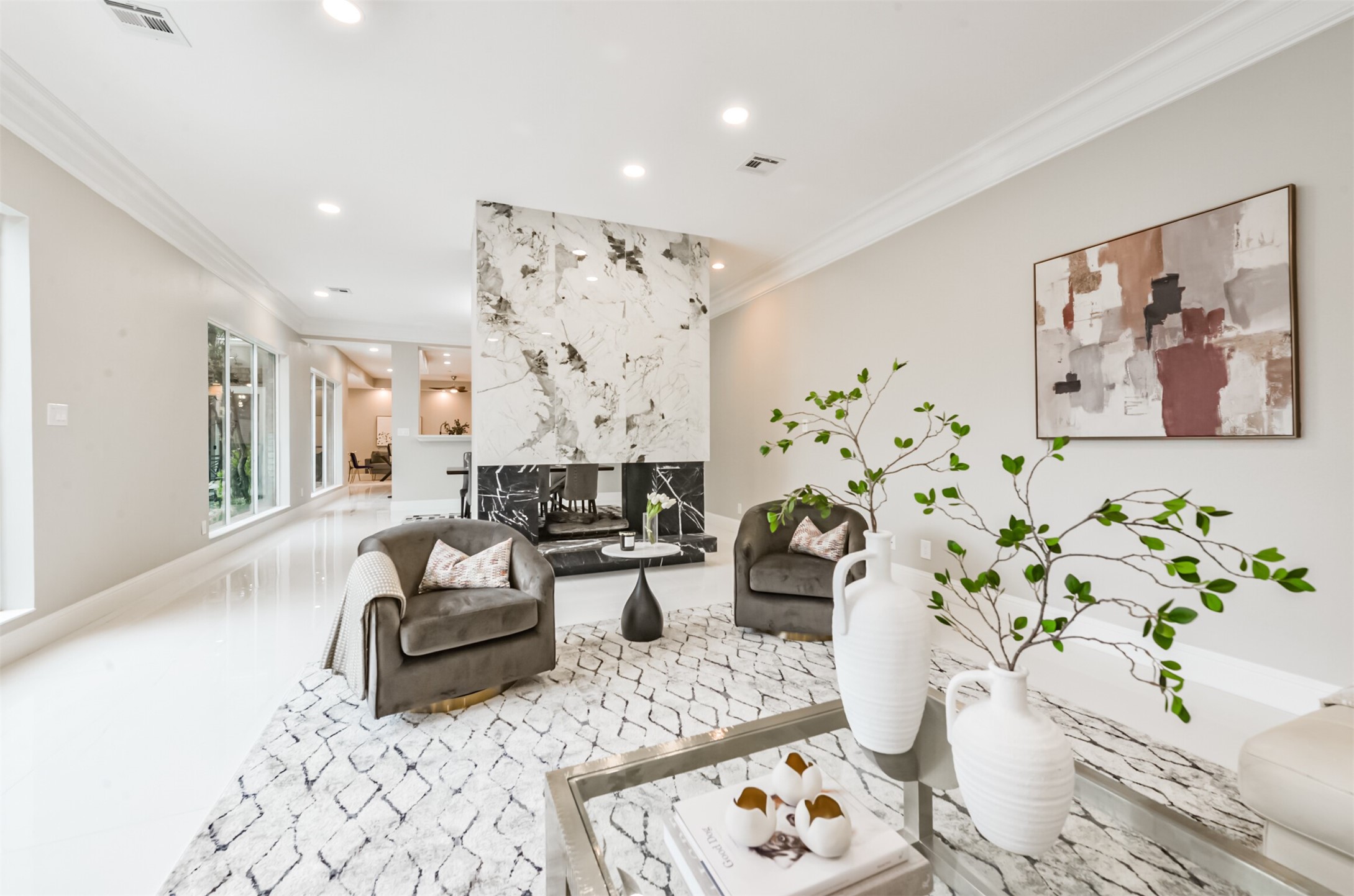 This COMPLETELY RENOVATED modern and inviting home is designed to impress. The striking double sided fireplace is a focal point that serves as both functional artwork and room divider between the formal living and dining spaces.