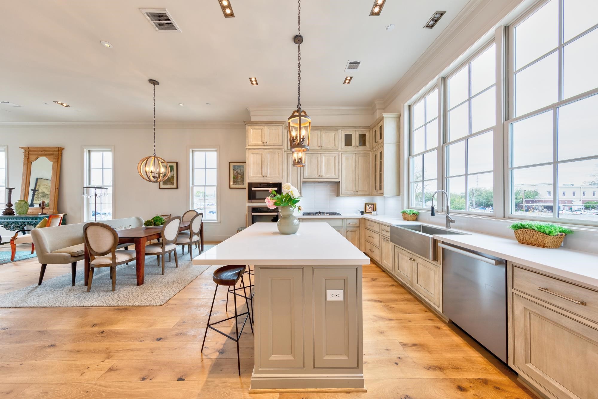 A spacious second floor main living area features 12' ceilings Gourmet Miele appliances and opulent spaces perfect for a quiet dinner at the oversized kitchen island or hosting a Thanksgiving feast!