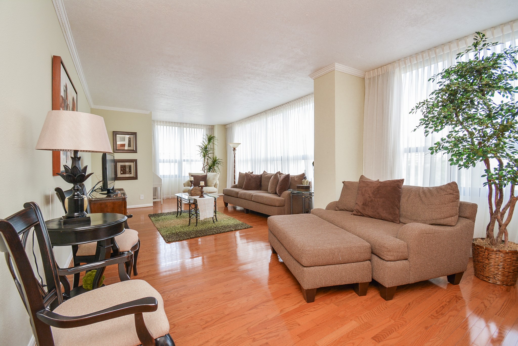 Corner unit with windows galore!!!  Wood floors in the living, dining and hallways.  This is the roomy living area.