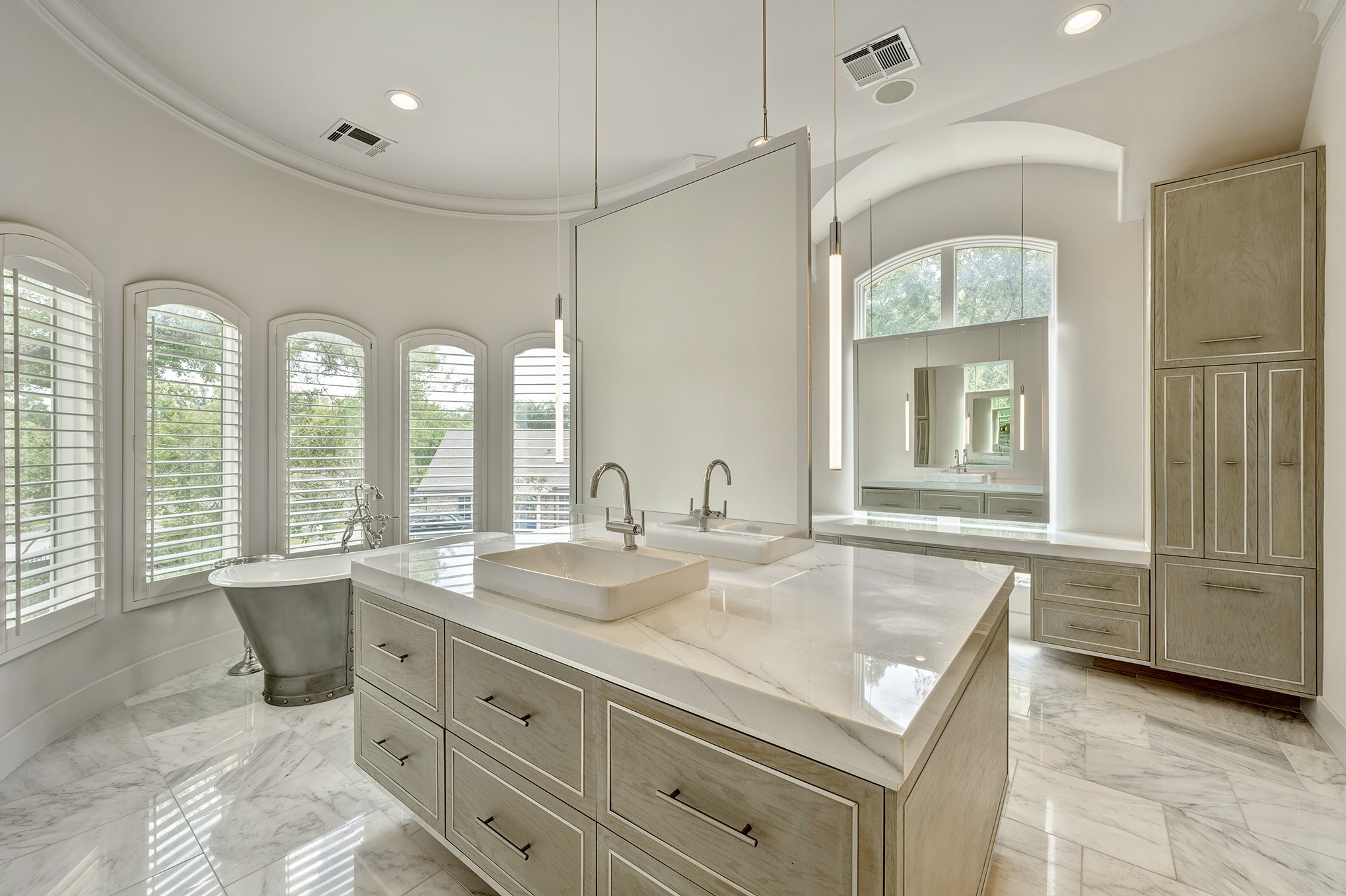 Primary en-suite bath with great lighting, free-standing tub, separate walk-in shower and vanity space