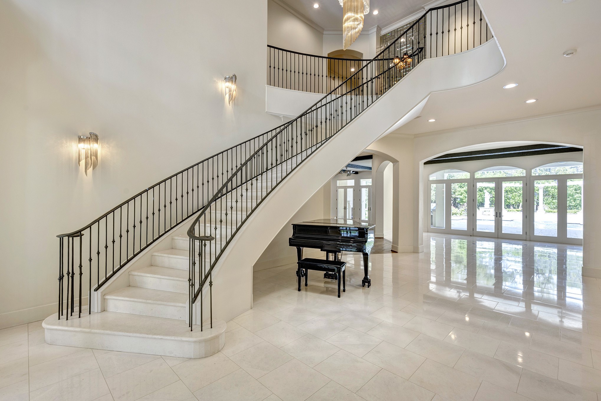 Formal Entry with limestone floors and stairwell with limestone treads, risers with iron rail