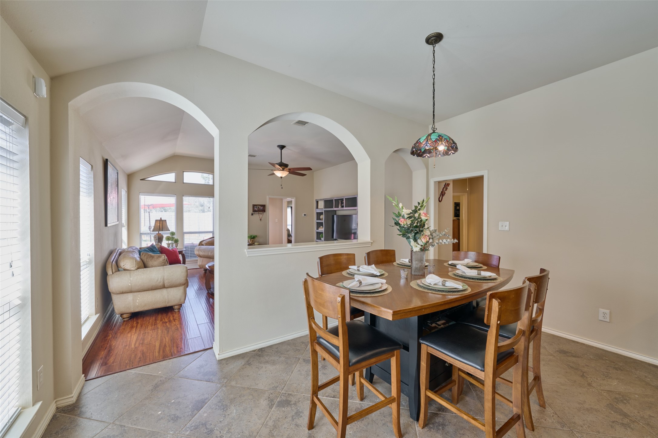 Tall arches divide the space but offer open views between the breakfast and family room.