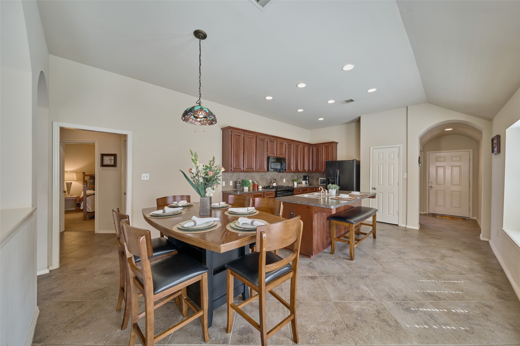 Great layout for breakfast and kitchen areas. Hall to left leads to the two secondary bedrooms, full bath and utility room.