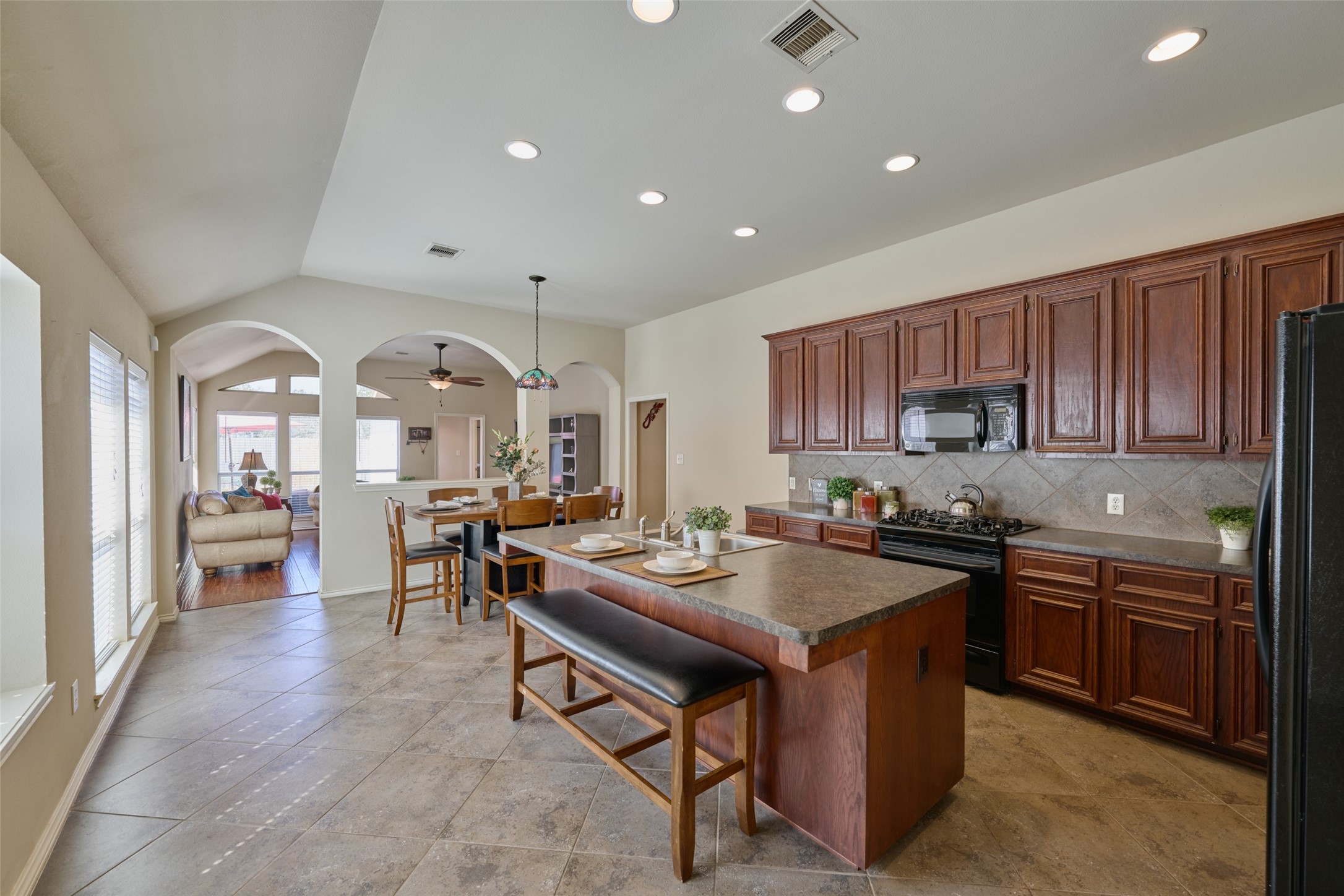 Amazing kitchen layout features an extensive island, gabled ceiling, 19