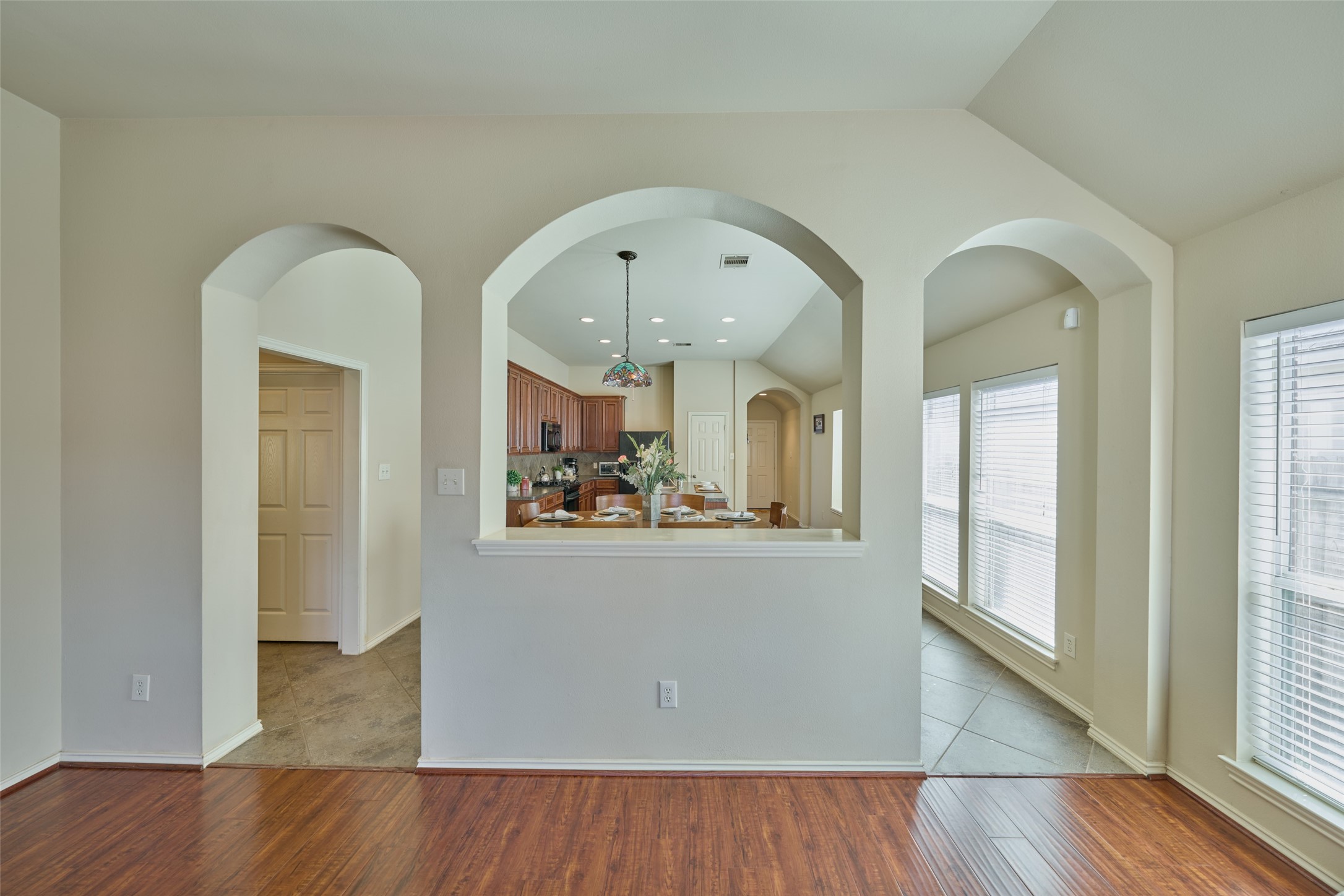 A view of the arches dividing the family and breakfast/kitchen. Just enough division to separate the space, but still open enough to see and hear what is happening from room to room.