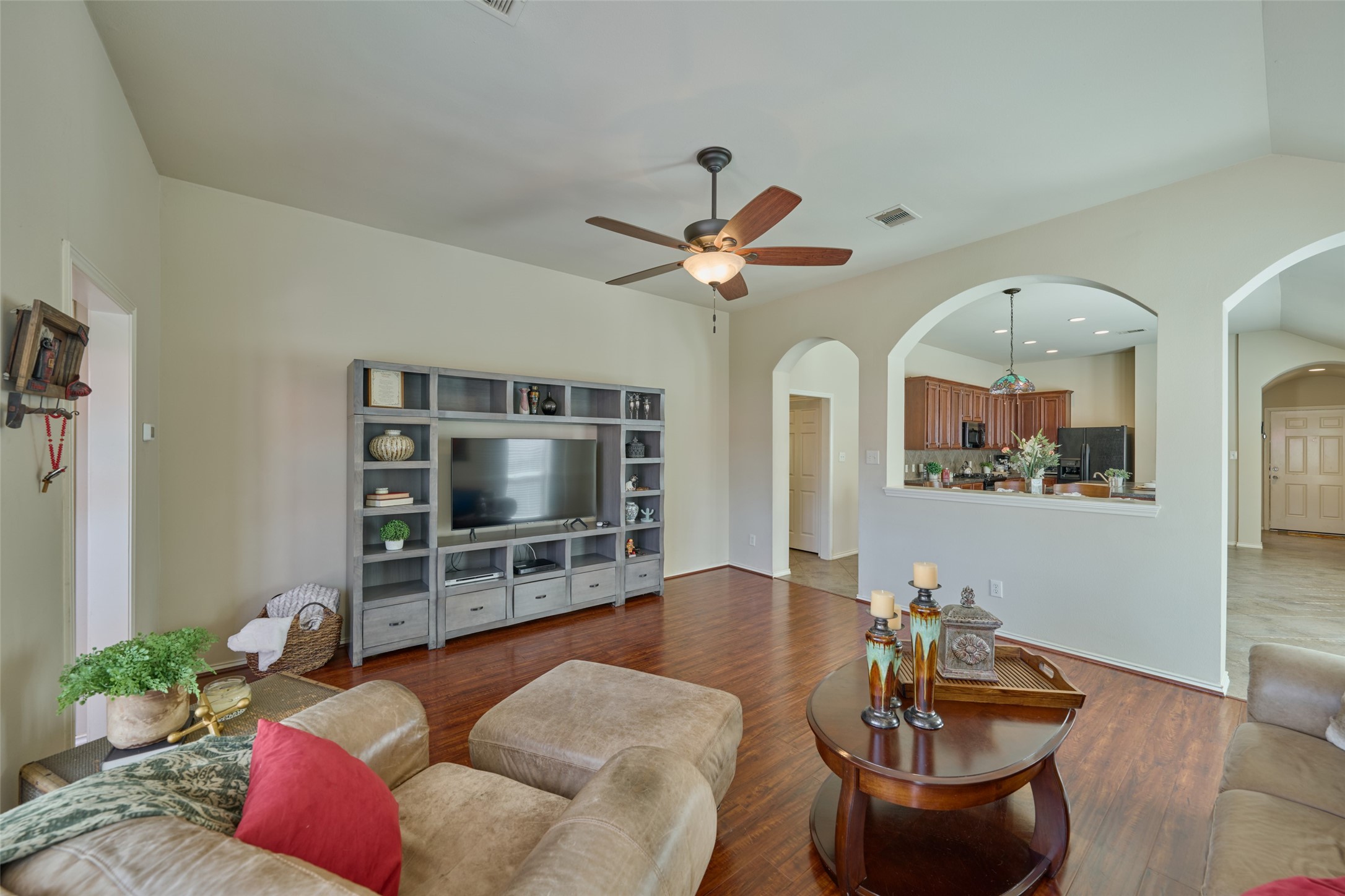 The family room is a great size and features laminate wood floors, tall ceilings, and natural light.