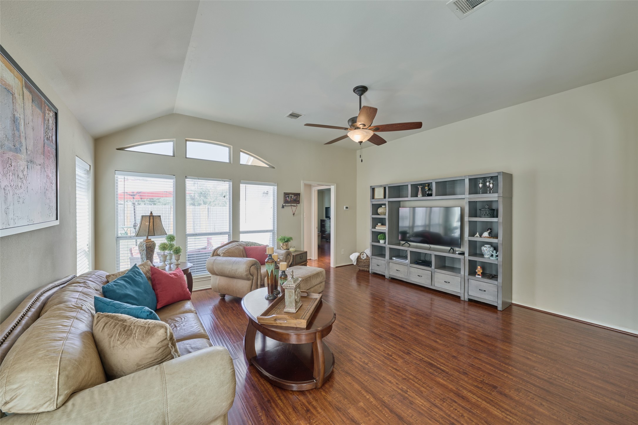 Family room is large and open with a wall of windows providing views to the backyard and greenspace.