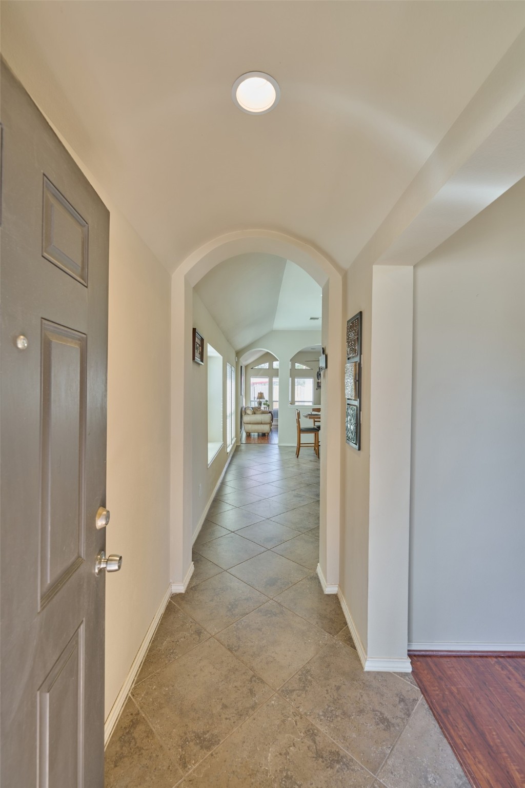 Beautiful arches and an extensive walkway through the home from the front door to the family room makes the home welcoming and inviting.