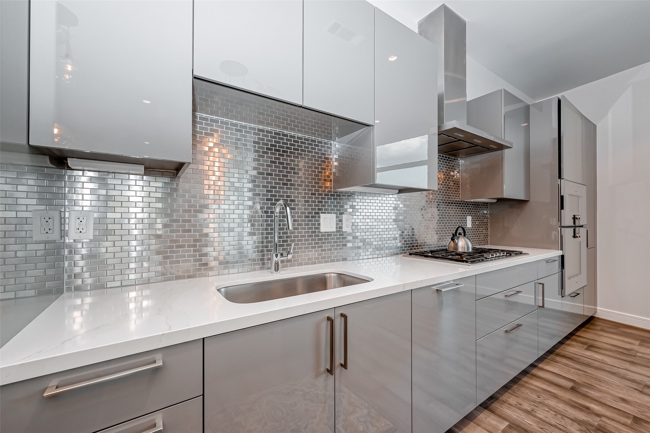 A more detailed view of the modern cabinetry and backsplash