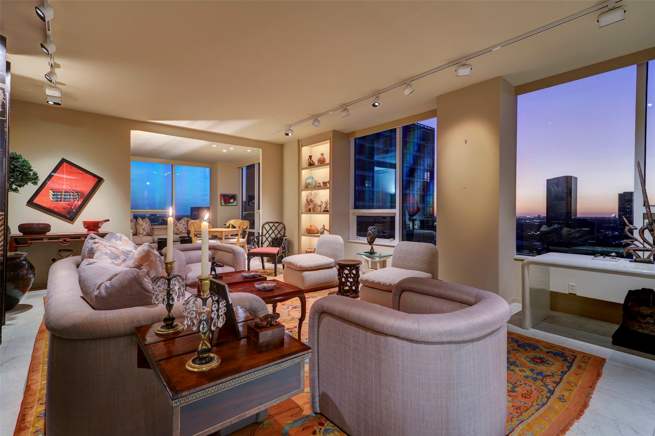 Timeless living area with lighted built-in shelves, marble floors and incredible sunset views.