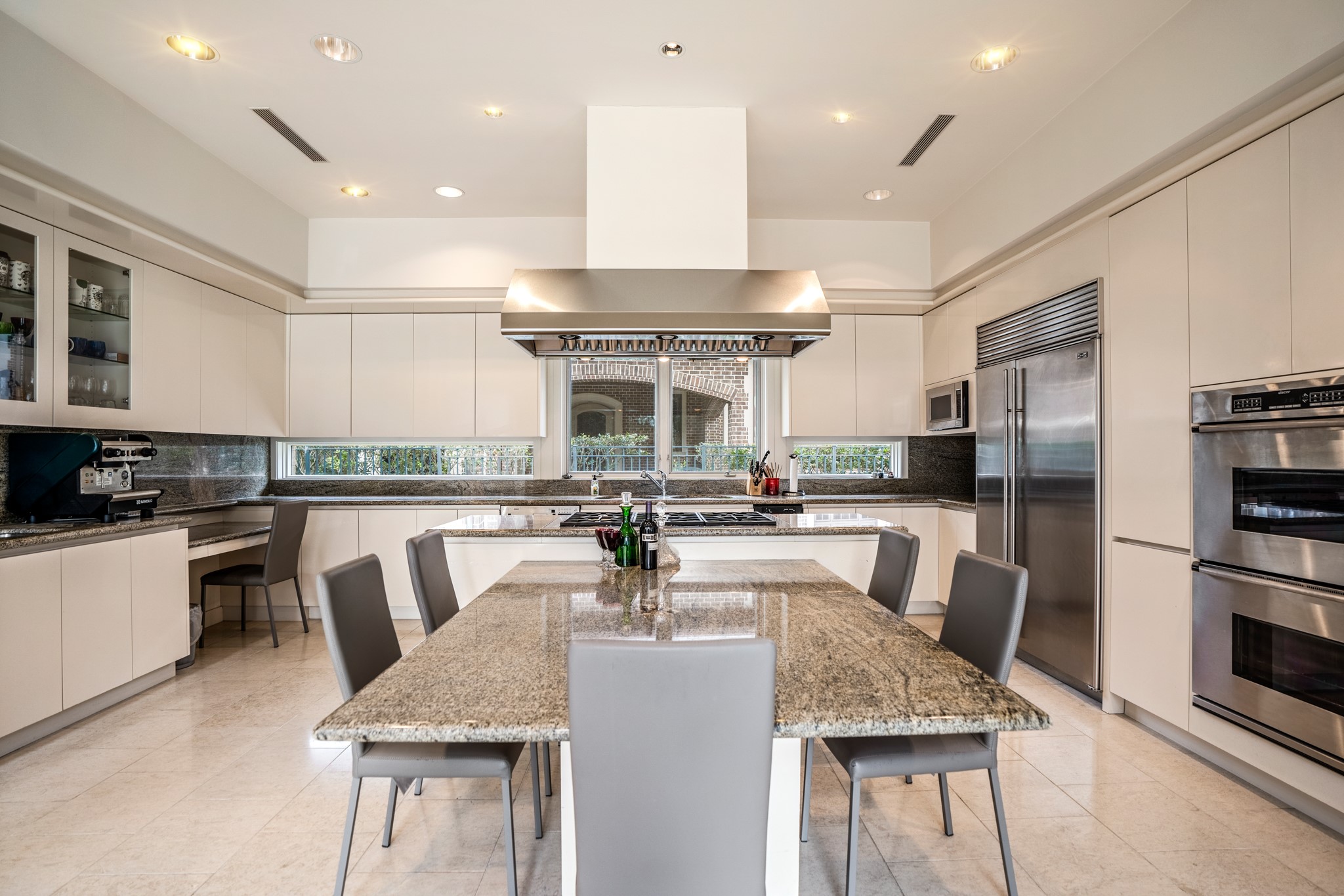 Timeless, classic cabinetry in this kitchen with double oven and built-in commercial-grade fridge. Granite table serves as an island and breakfast bar. Seats 5 people comfortably.