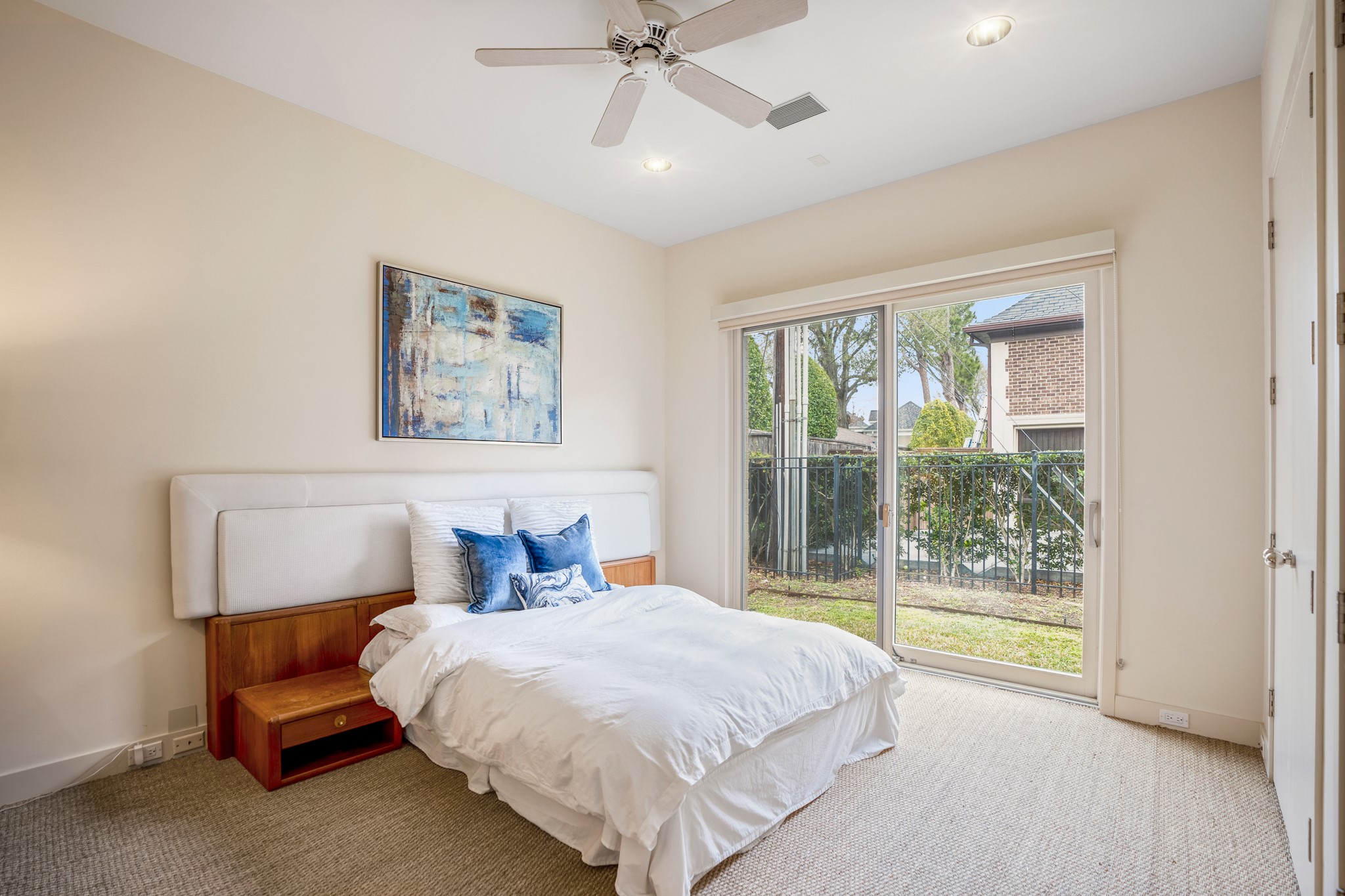 A first-floor bedroom with en-suite bathroom. Sliding glass doors lead you to the side yard.