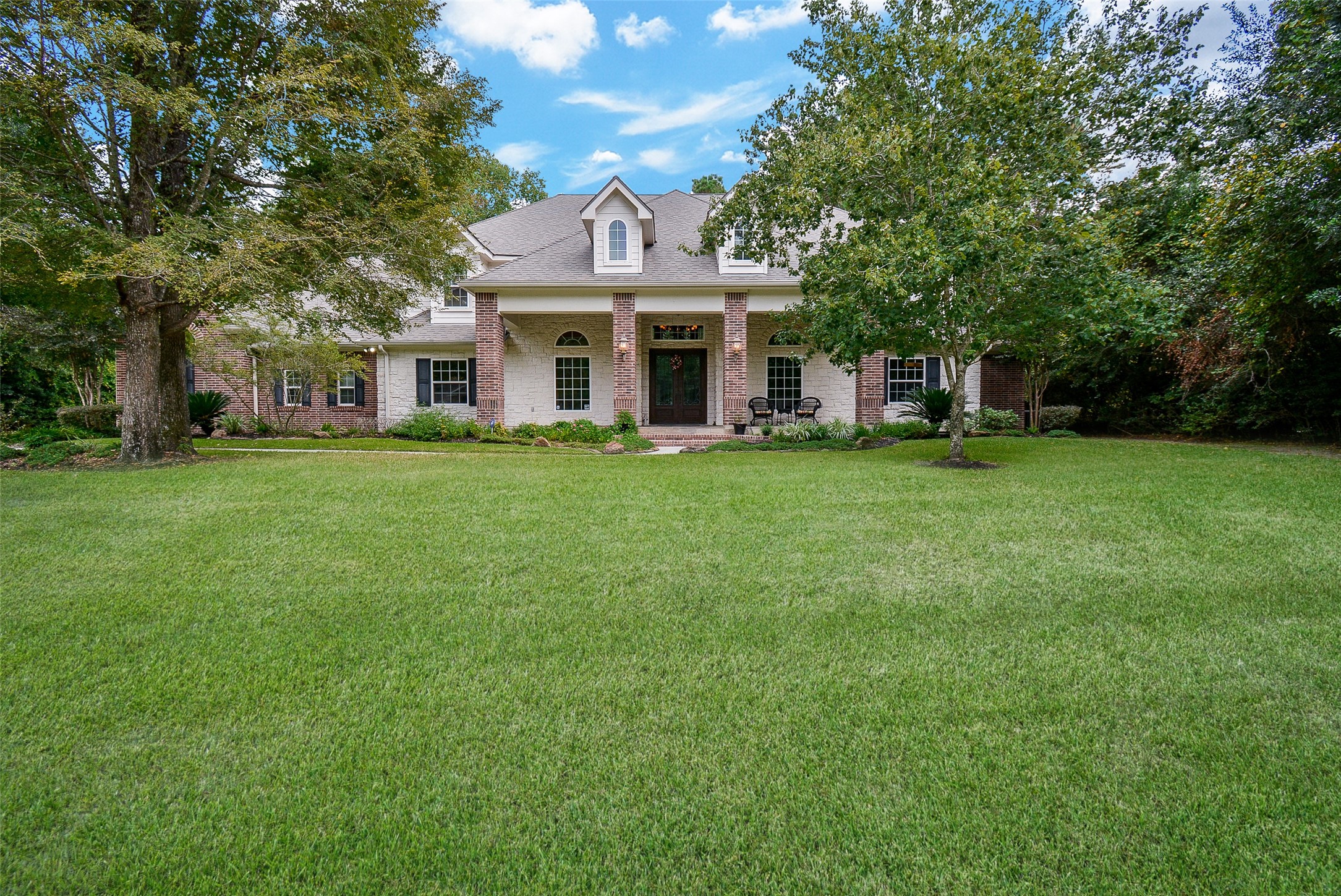 Elegance & Classic Beauty are throughout this Custom Designed & Built Spacious 2-Story Home in the Intimate & Highly Desired Gated Timberlake Village on over 3/4 Acre Wooded Lot. Approx. 16x14 Beautiful Covered Front Porch with Stained Bead-Board Ceiling.