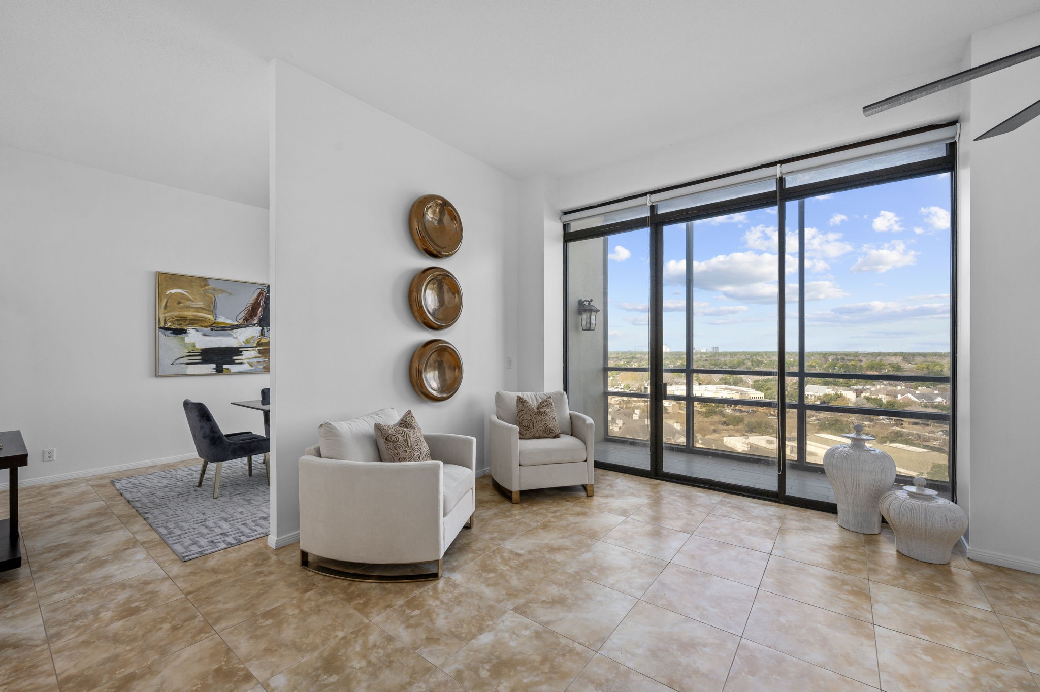 Additional sitting area off the living, overlooking the private balcony and westward skyline views.