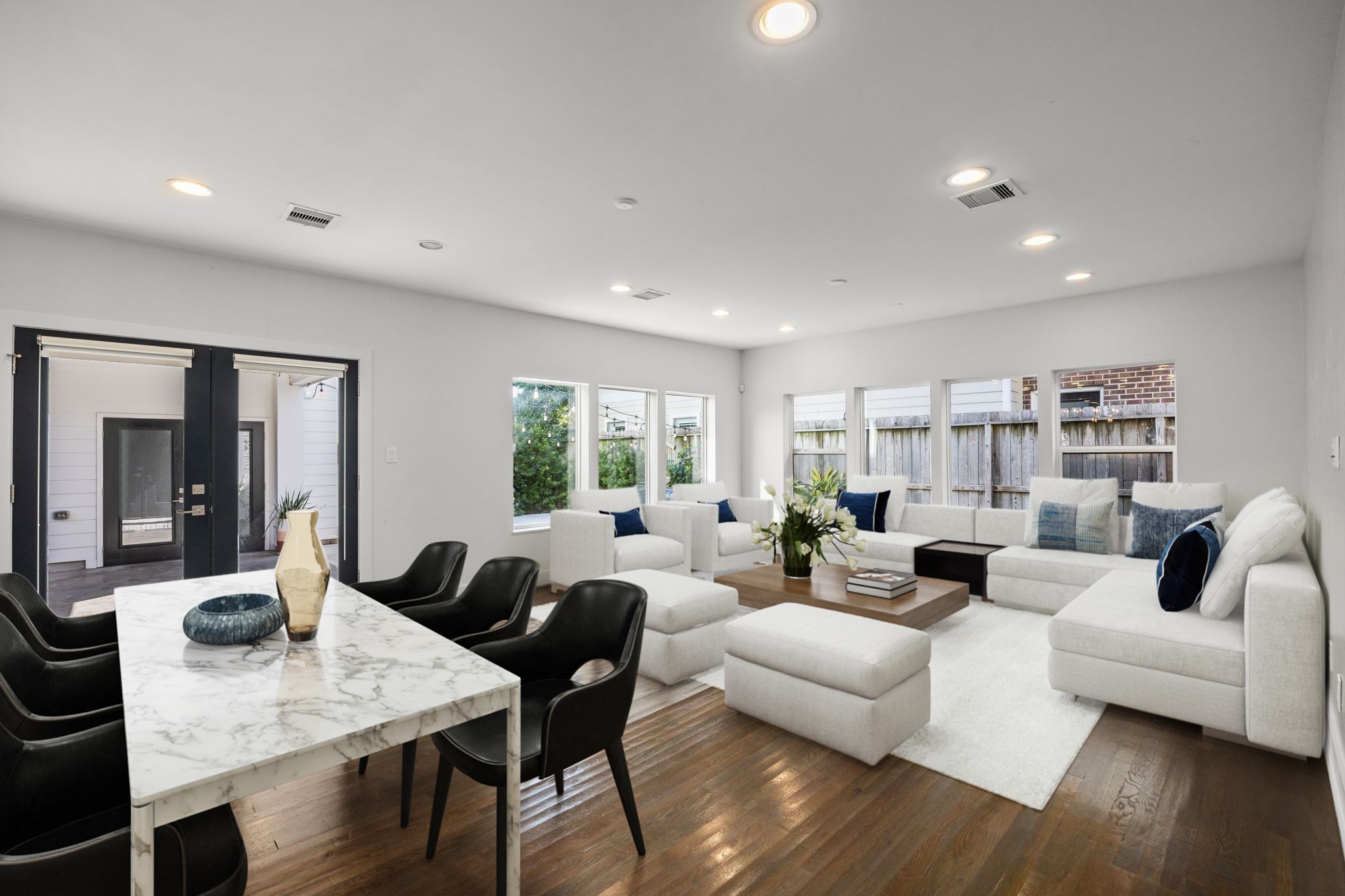 Gorgeous natural light pours through the home, including the formal dining room, spacious living room with picture windows overlooking the pool and backyard, and chef's kitchen.