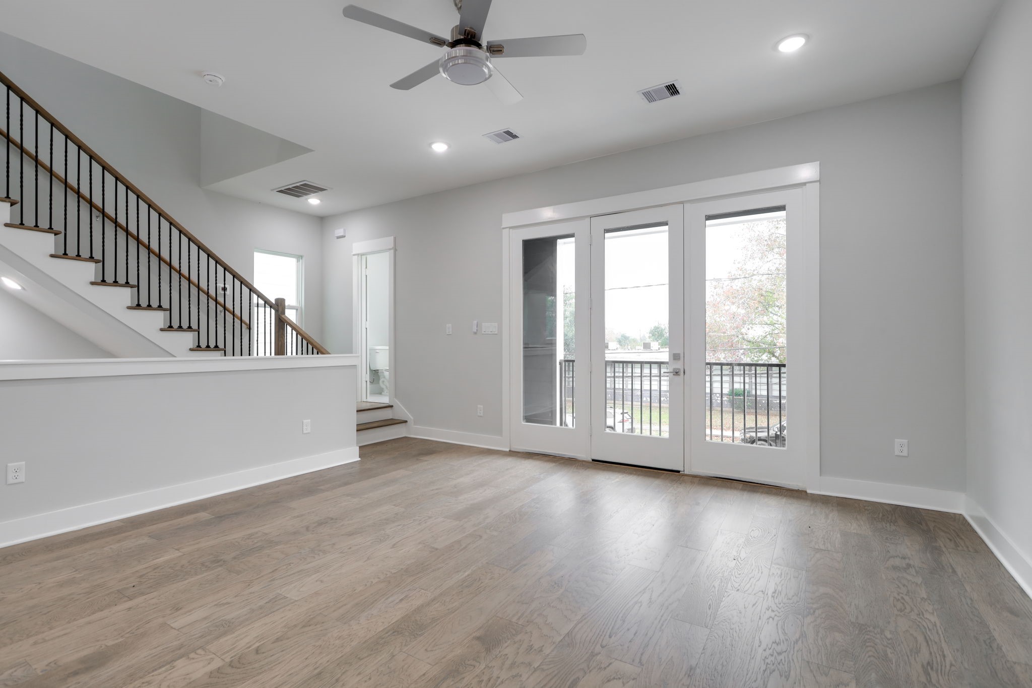 The spacious living room leads out to the balcony overlooking the quiet neighborhood.