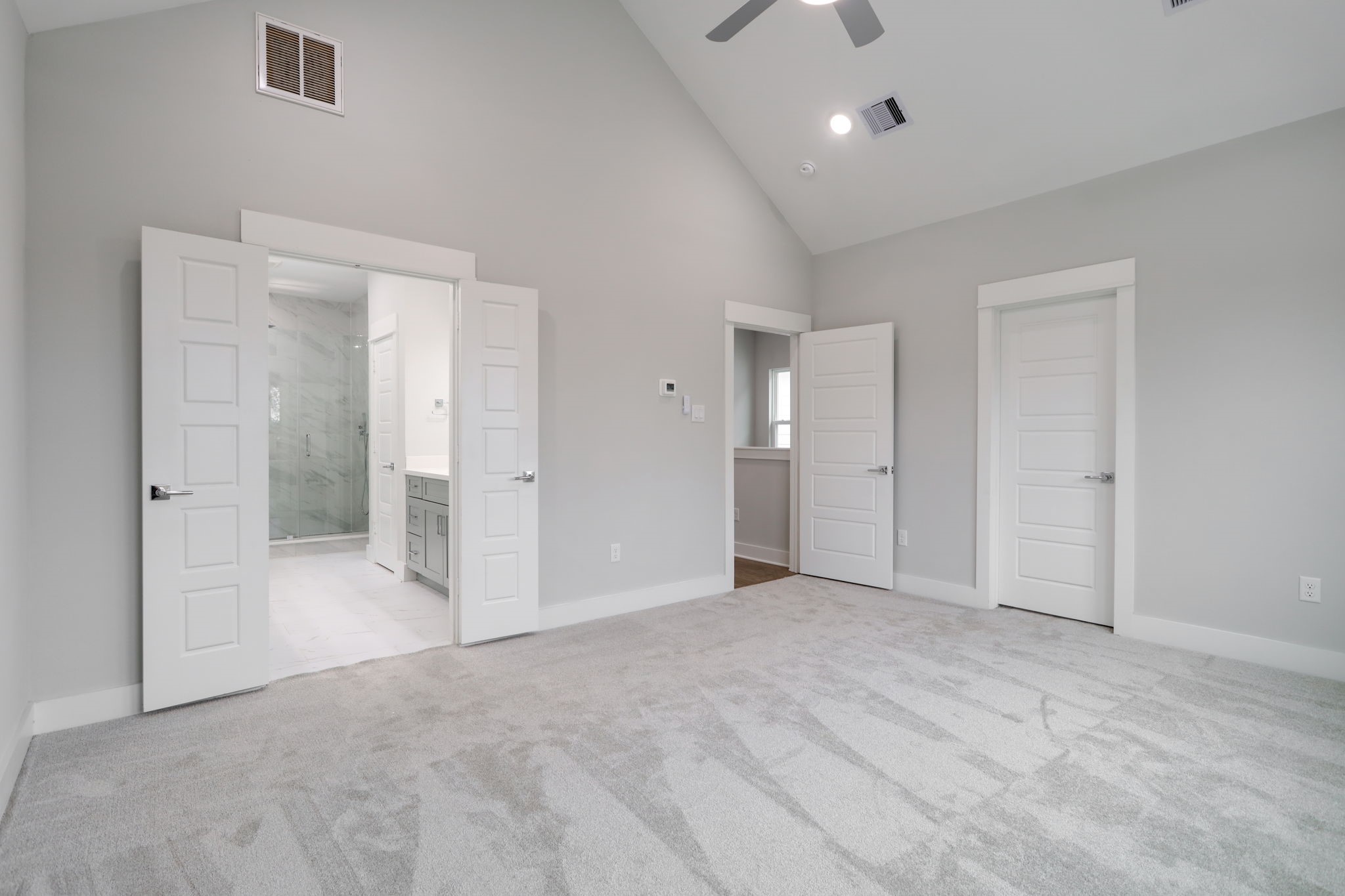 The primary walk-in closet that's located by the entrance is filled with natural light and is approximately 10 x 7.