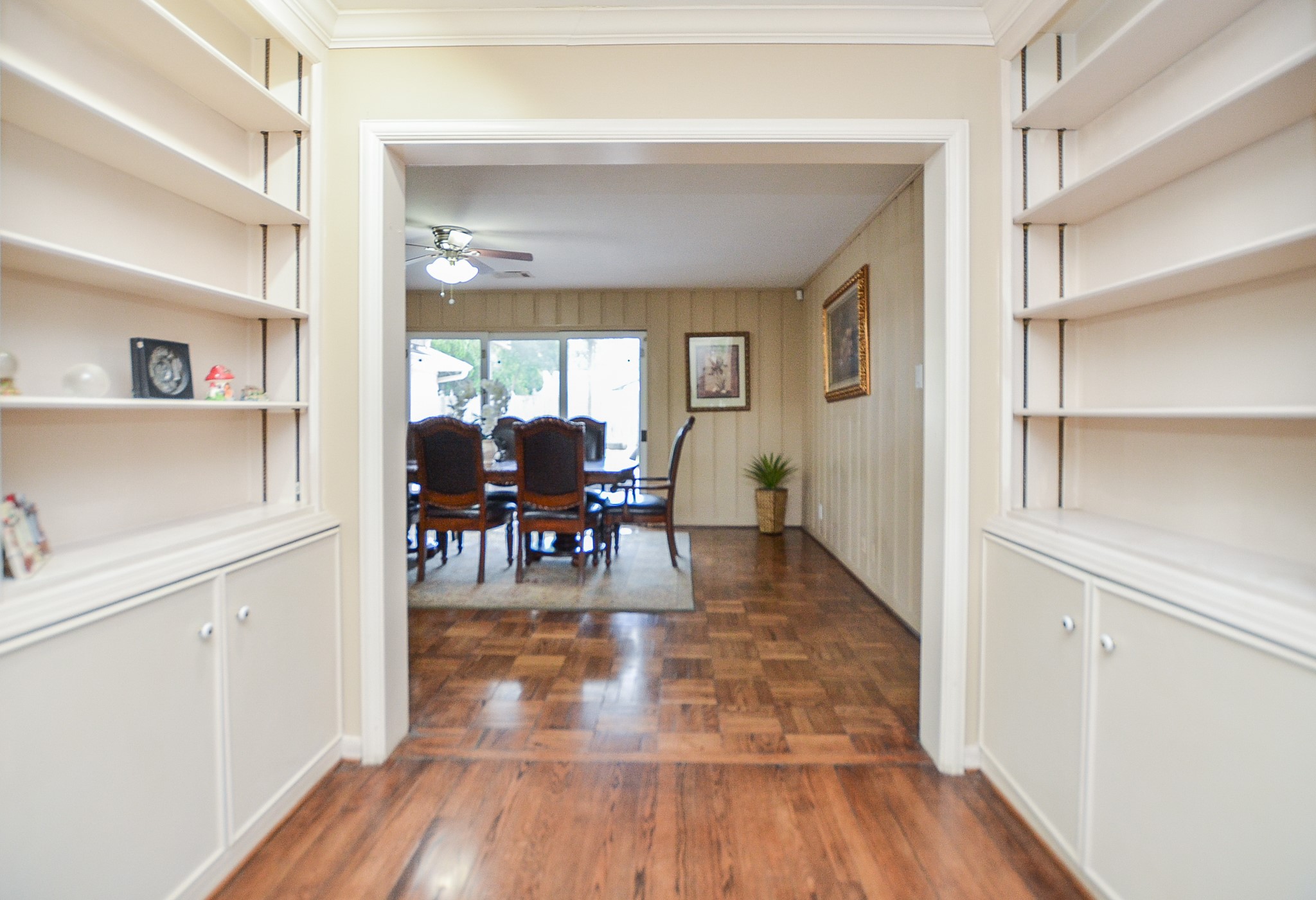 What a lovely sight! Built-in wall storage on opposite sides of this hardwood floor path, just off the formal dining area.