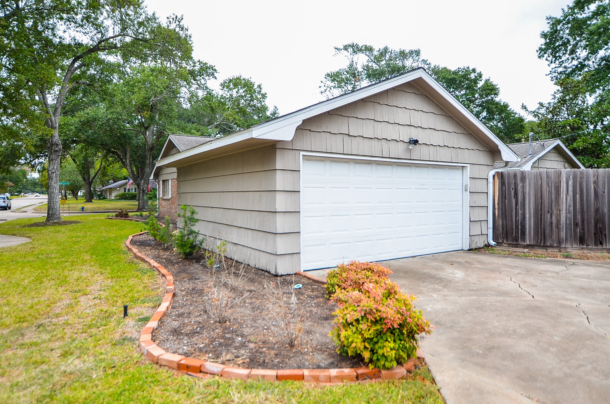 The dual-car attached garage is pristine looking above a roomy driveway.