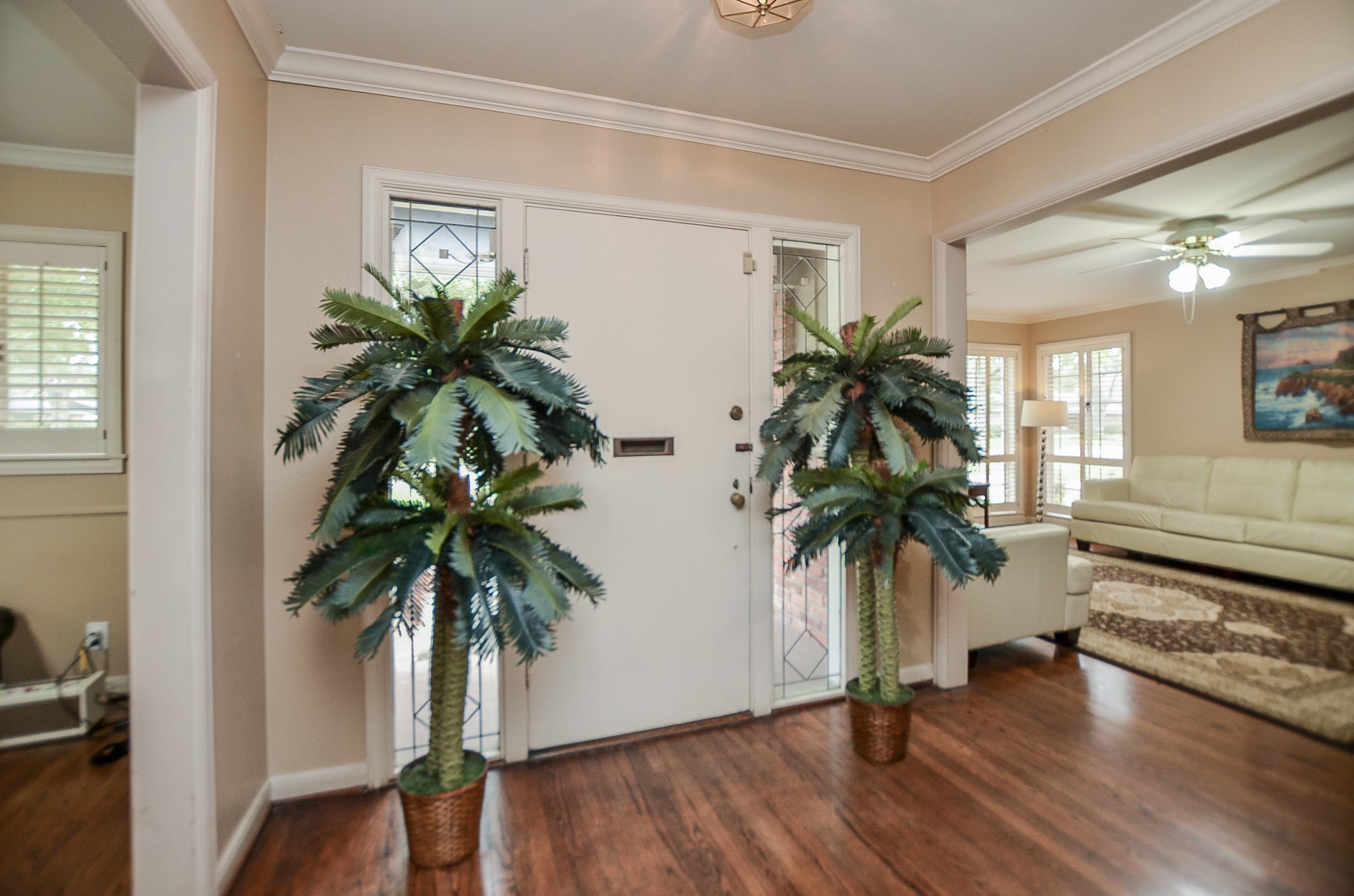 This is your bright main entrance from the inside; with cool neutral tones on walls; and the timeless beauty of original hardwood flooring in all major areas.