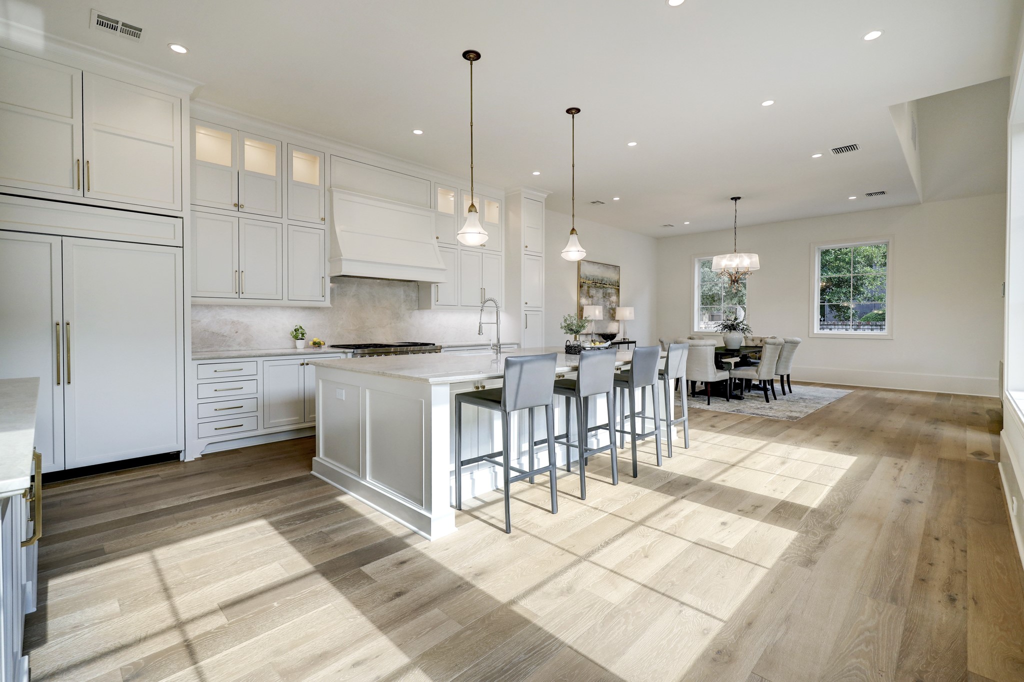 Kitchen features custom cabinetry, Wolf range and Subzero refrigerator and wine cooler.