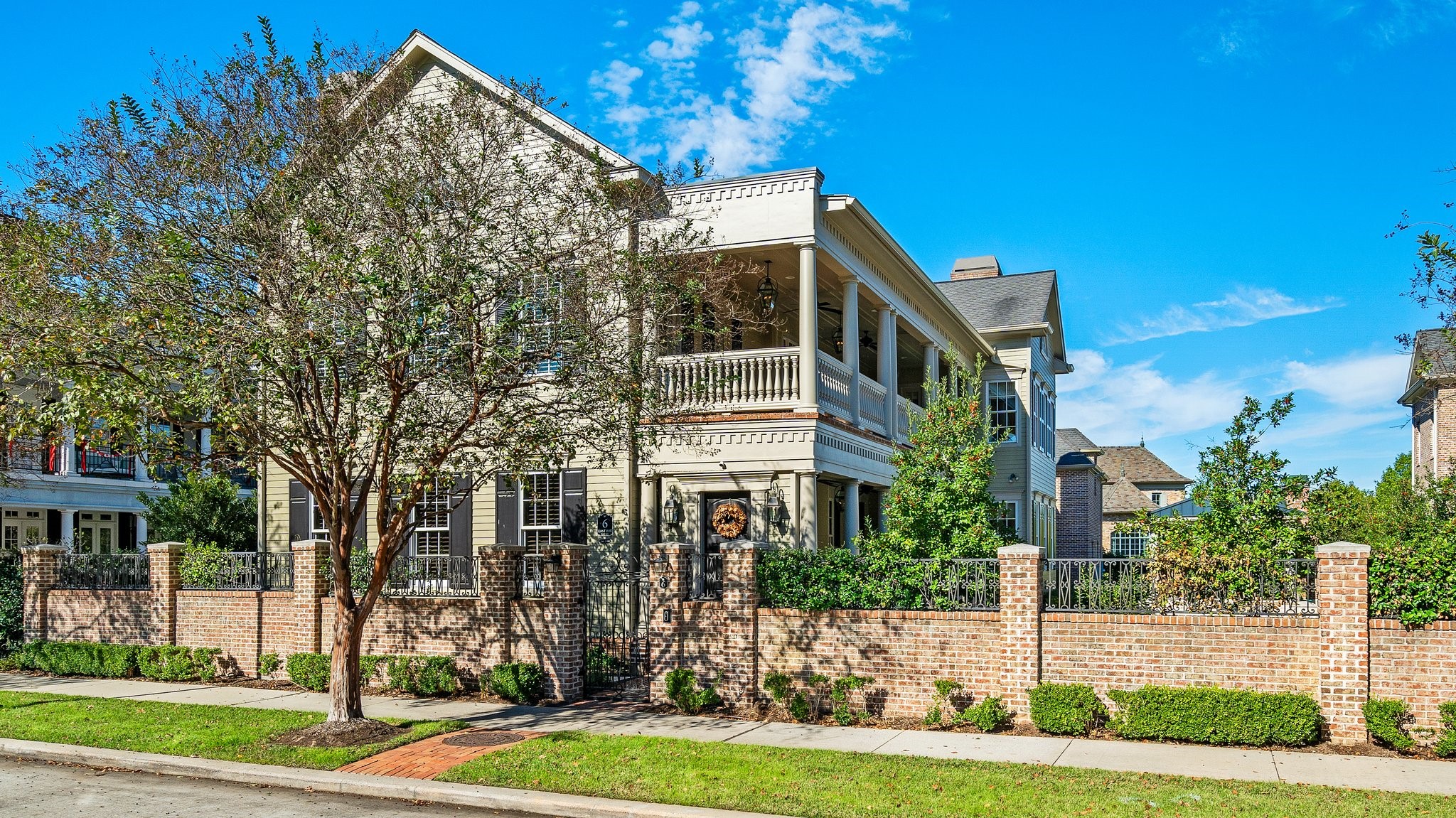Dreams do come true in this gorgeous home on East Shore!  Reminiscent of Charleston, this stately home with oversized front porch and balcony is all about location, and East Shore is where it is at in The Woodlands!