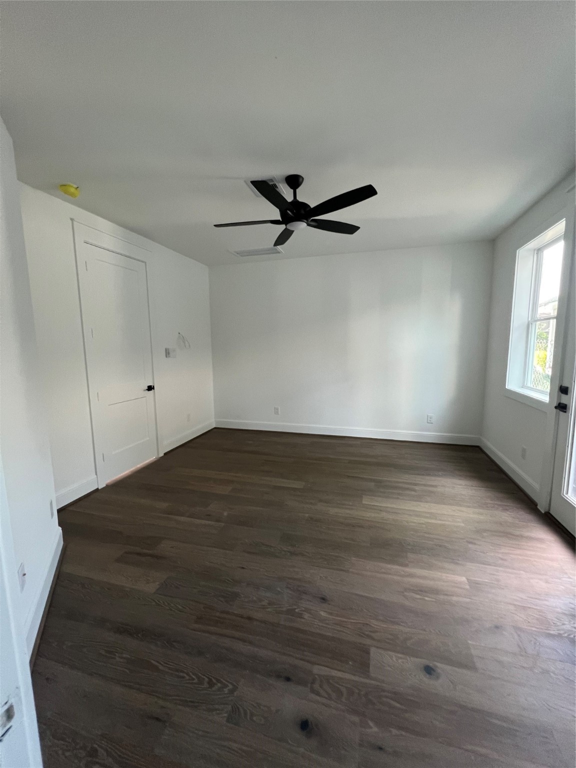 The Primary bedroom does not dissapoint with white oak floors, iron ore trim and baseboards to coordinate with the detailed ceiling treatment. The modern chandelier and accent wall tie this room together. Speakers are also found here and the family room.