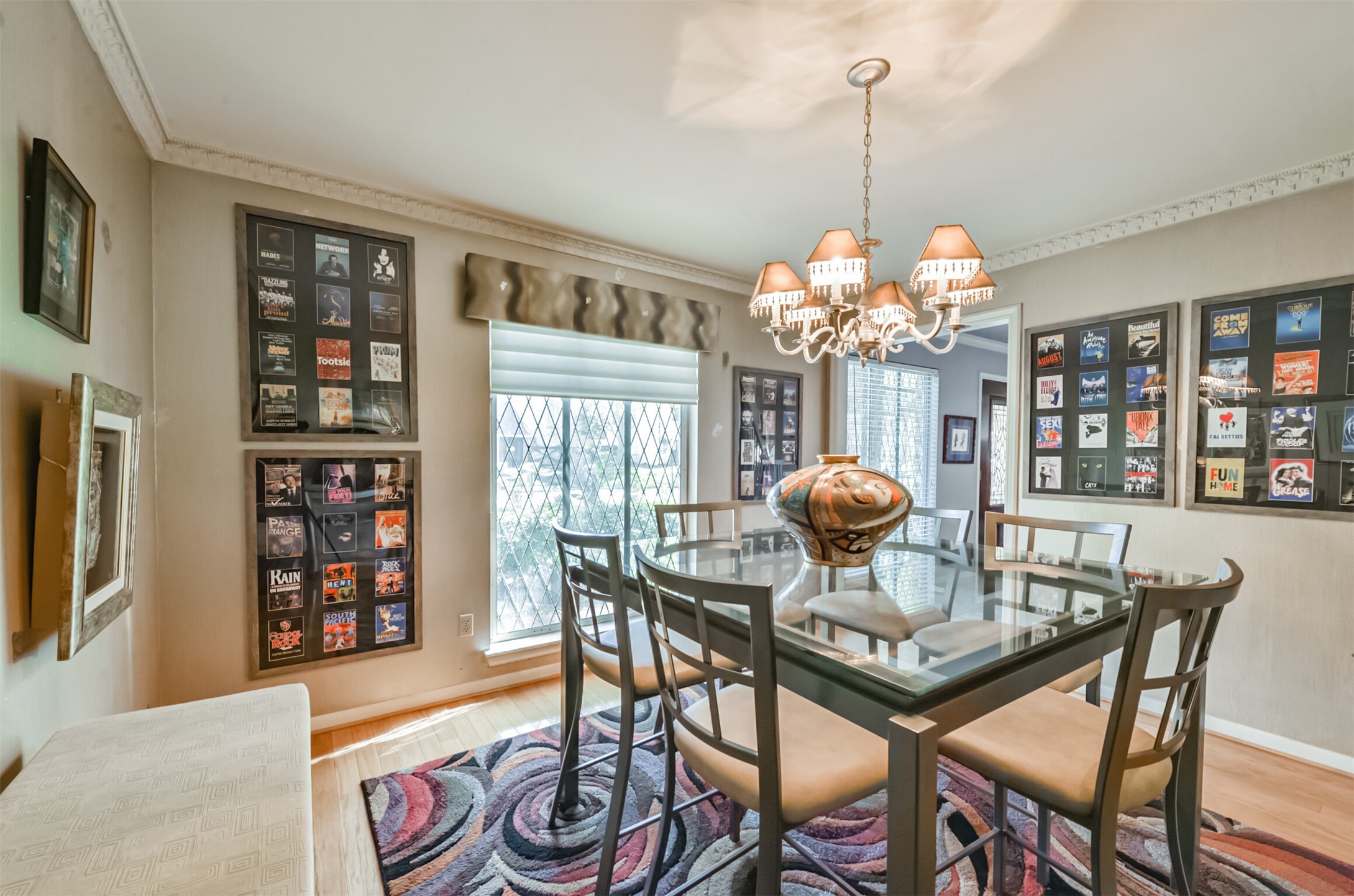 Custom paint and framed Playbills line the walls and are an instant conversation starter for dinner guests. The diamond shaped leaded glass windows look out over the front yard.