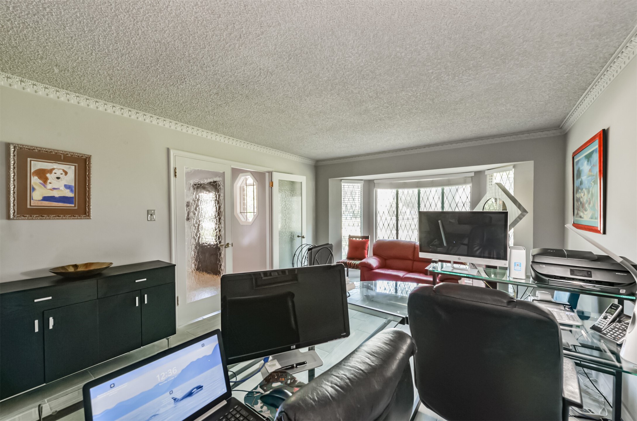 This space is traditionally the formal living room but the seller uses it as his office. The sheer size and view out the window make it fit for a VIP.