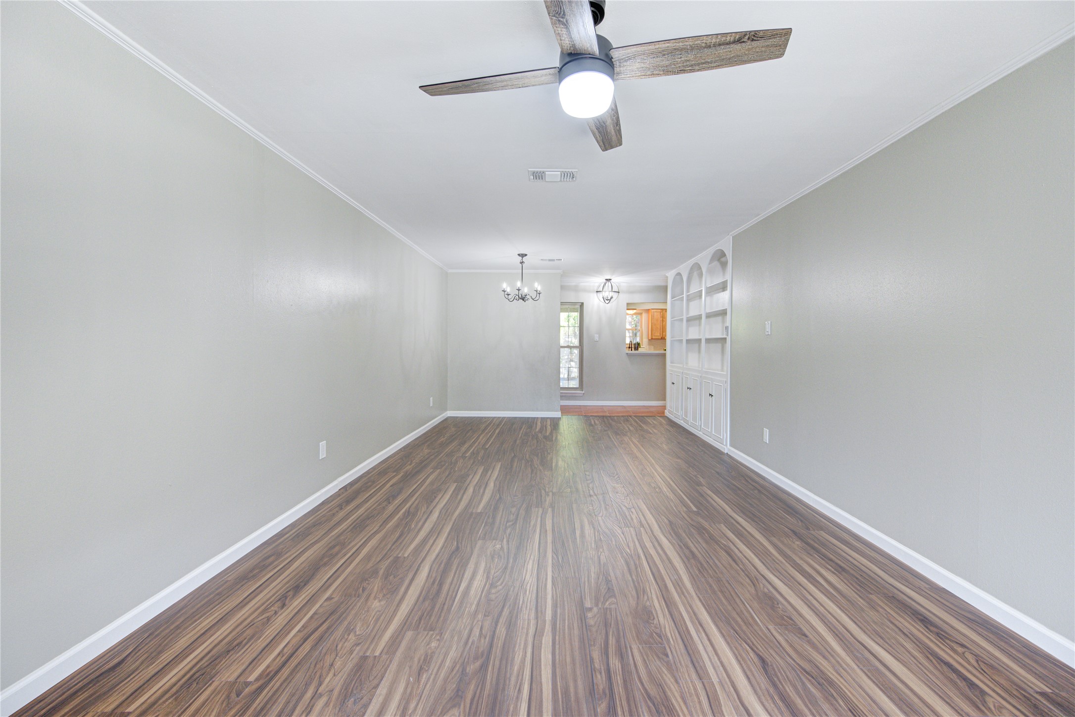 The new laminate flooring flows through the living/dining room, the main hallway, and into both bedrooms. Each room has a new sleek ceiling fan to reduce our sky-high electric charges.