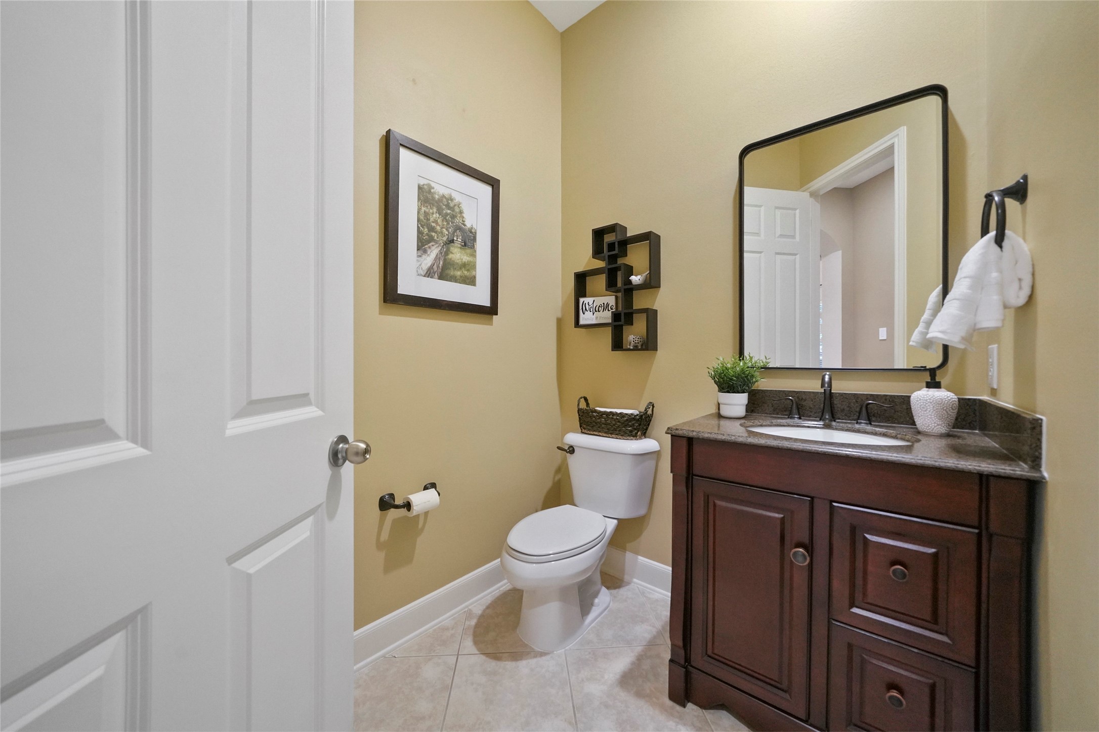 The powder room is a cheerful space where guests can freshen up.