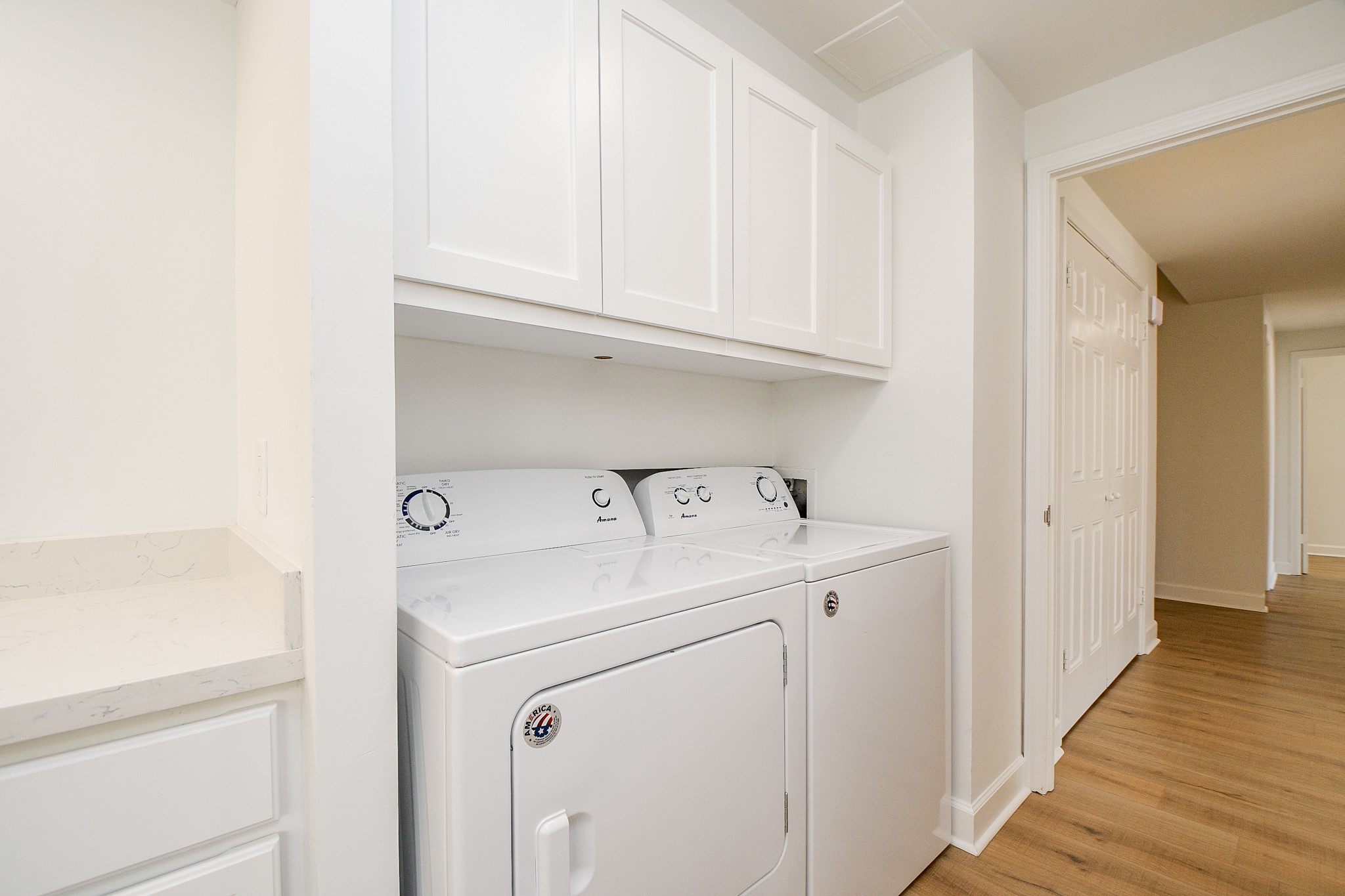 The washer and dryer are located in this adjacent hallway to the kitchen.