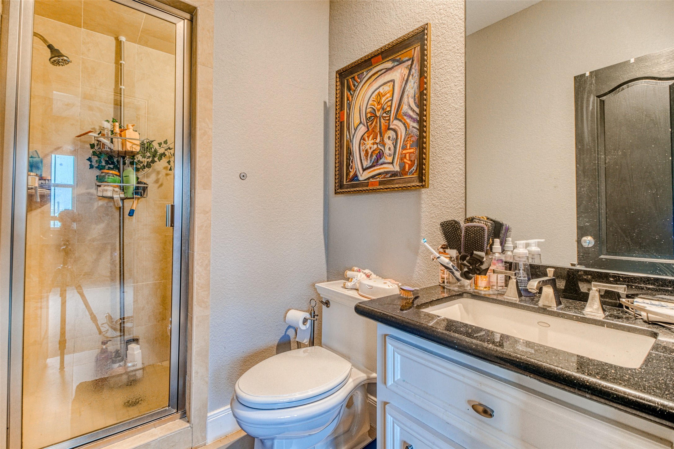 The fourth floor bathroom is chic and contemporary with neutral tones, undermount sink and a full tile surround walk-in shower with built-in bench - only the best for family and long-term guests.