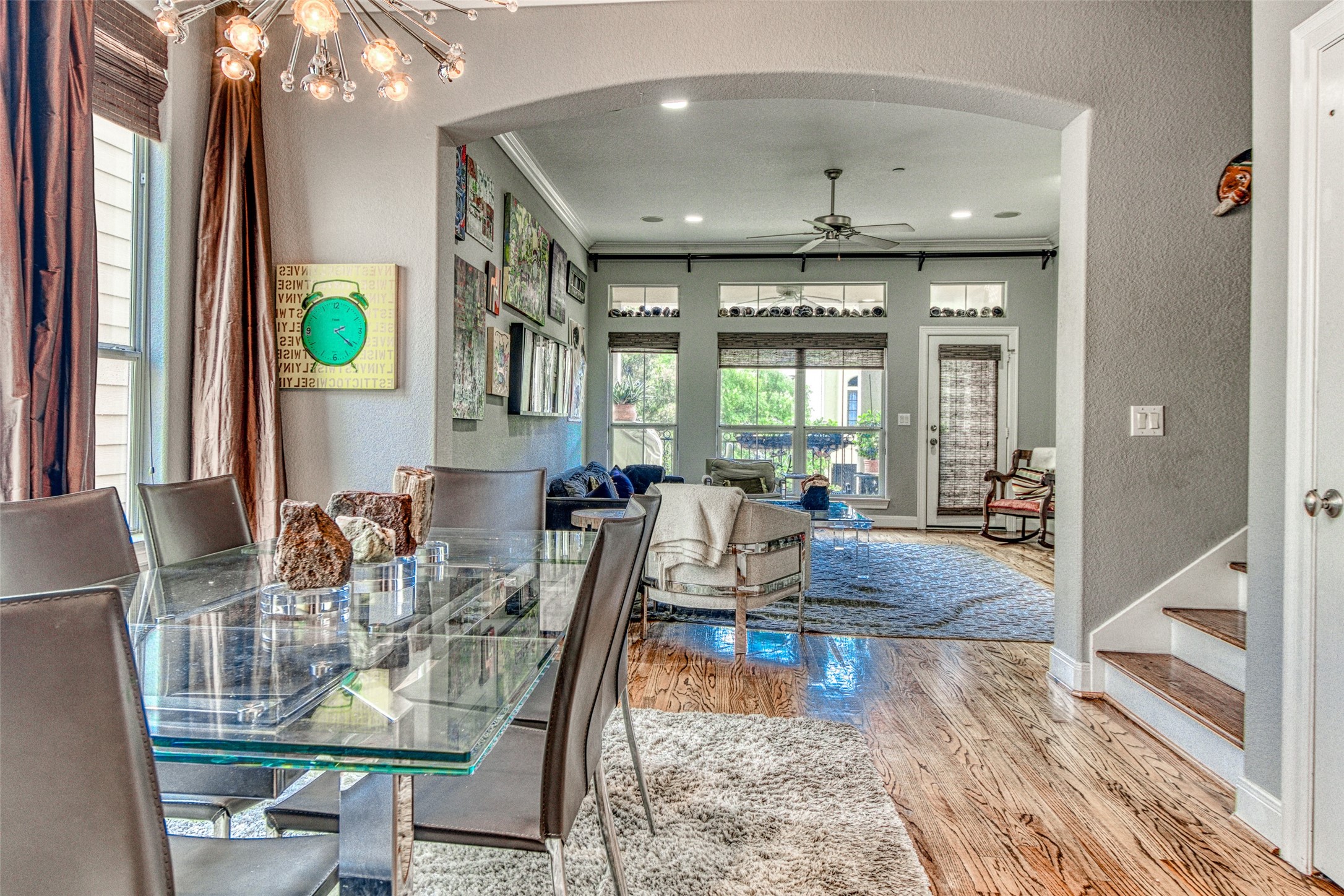 An abundance of natural light floods the home through large double-paned windows and transoms, soaring high ceilings, and recessed lighting combine to create a bright, airy ambiance in this open-concept floorplan.