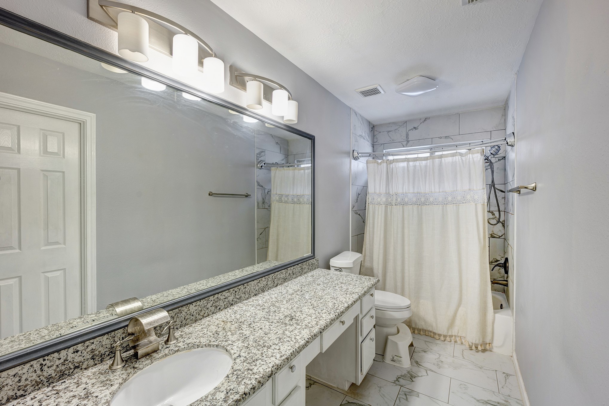 Primary Bath has walk in closet/ tub/shower combo. sit down vanity