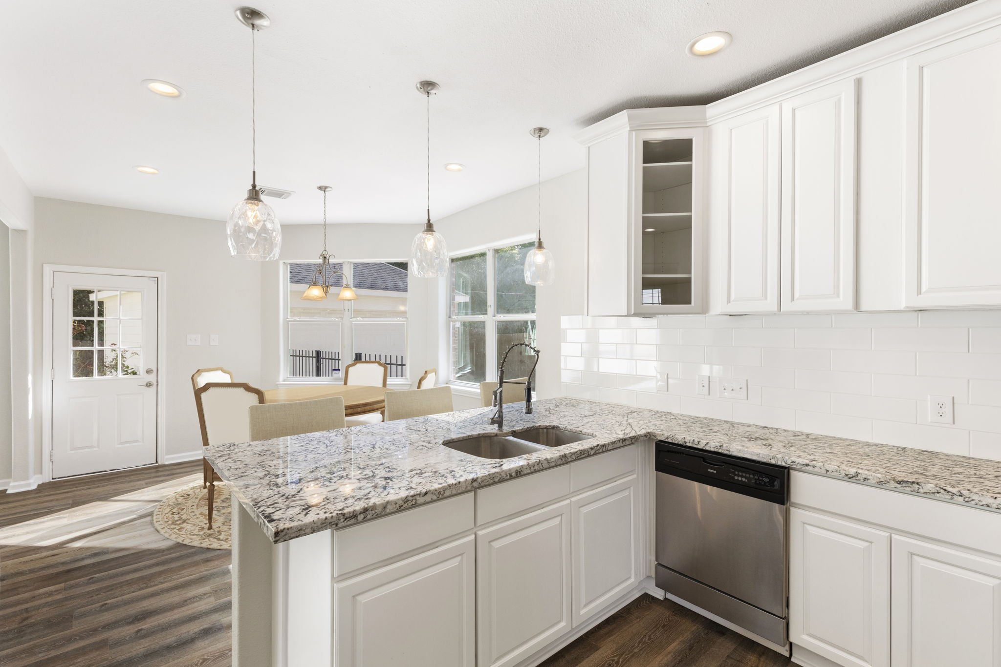 This dream kitchen offers stylish granite countertops with white subway tiled backsplash, 42