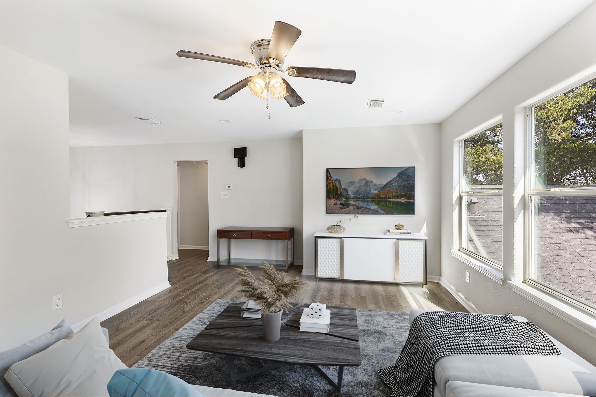 Upstairs, you will find the ample sized game room/sitting room with new flooring, ceiling fan and recess lighting.  ** This image has been virtually staged