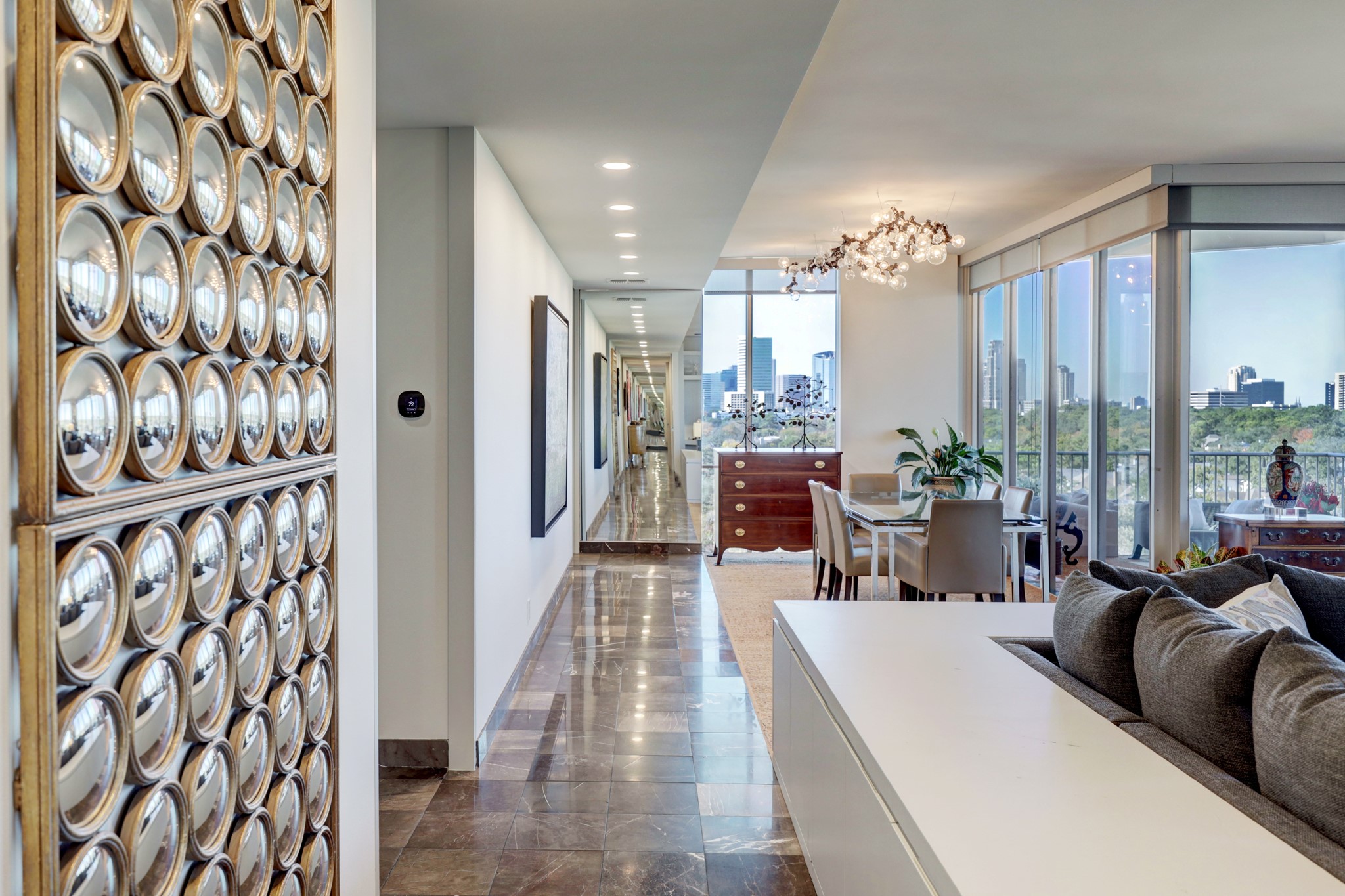 Reception / Formal Rooms]
The foyer expands into the light filled reception area and formal rooms. Lavish use of mirrored walls adds depth to the open floorplan. Full length windows, glass sliding doors, and a wide tiled balcony enhance spacious, elegant formal rooms.