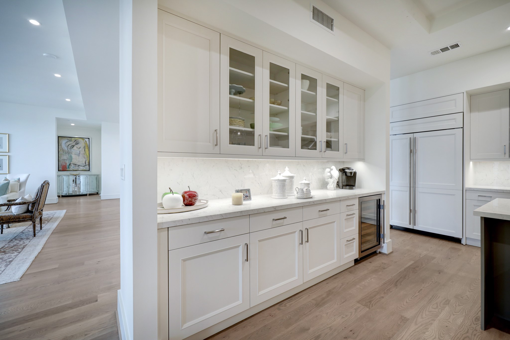 The Kitchen's built-in buffet cabinet features glass front cabinets with under cabinet lighting, quartz counter/backsplash with cabinets and drawers below, Sub-Zero wine cooler.  Perfect for entertaining!
