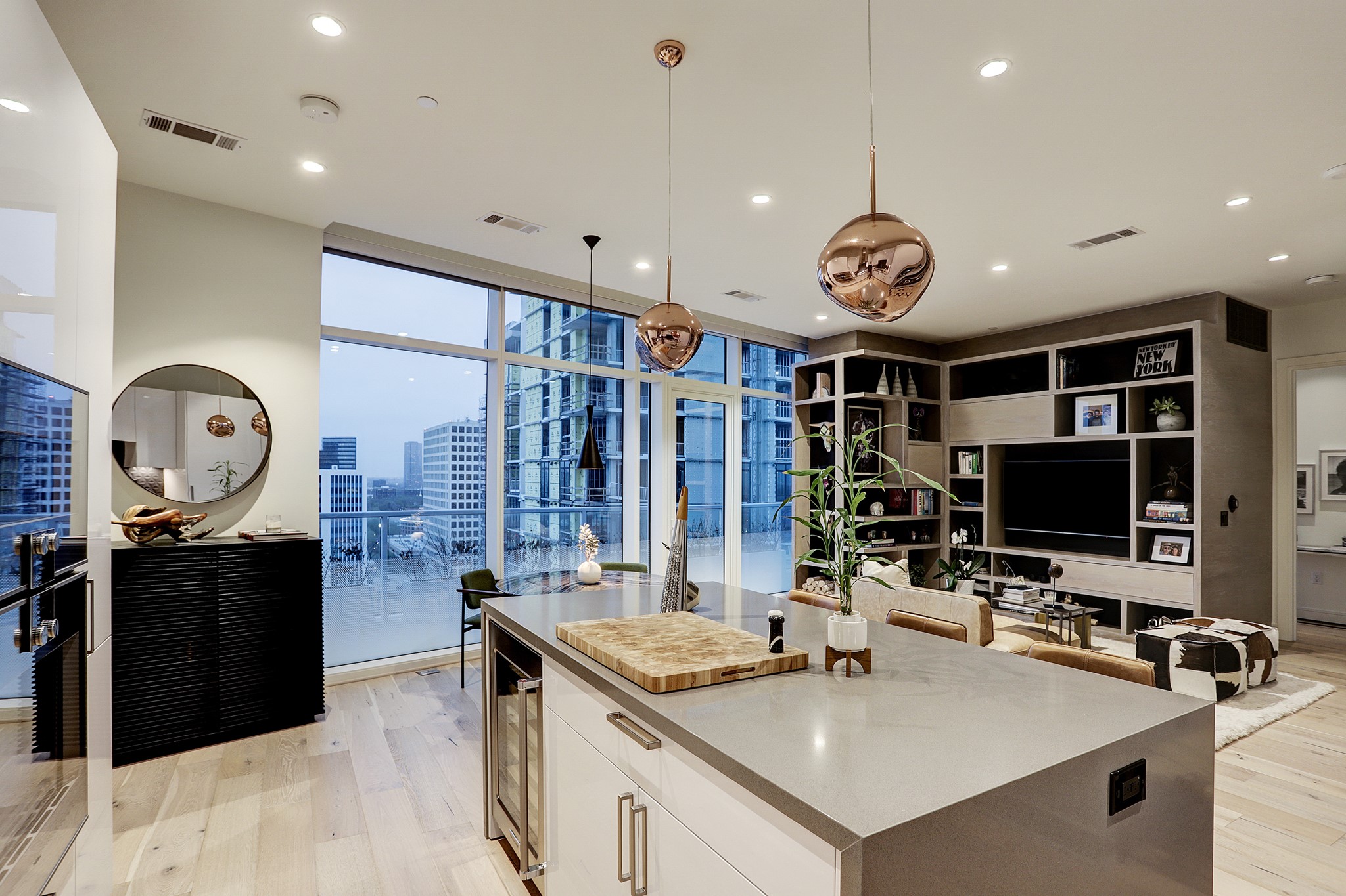 The CHEF'S ISLAND KITCHEN has stainless Gaggenau appliances and elegant Eggersmann cabinetry.  Notice the beverage chiller at the end of the island, the copper pendant lights above and the bronze cabinet hardware.