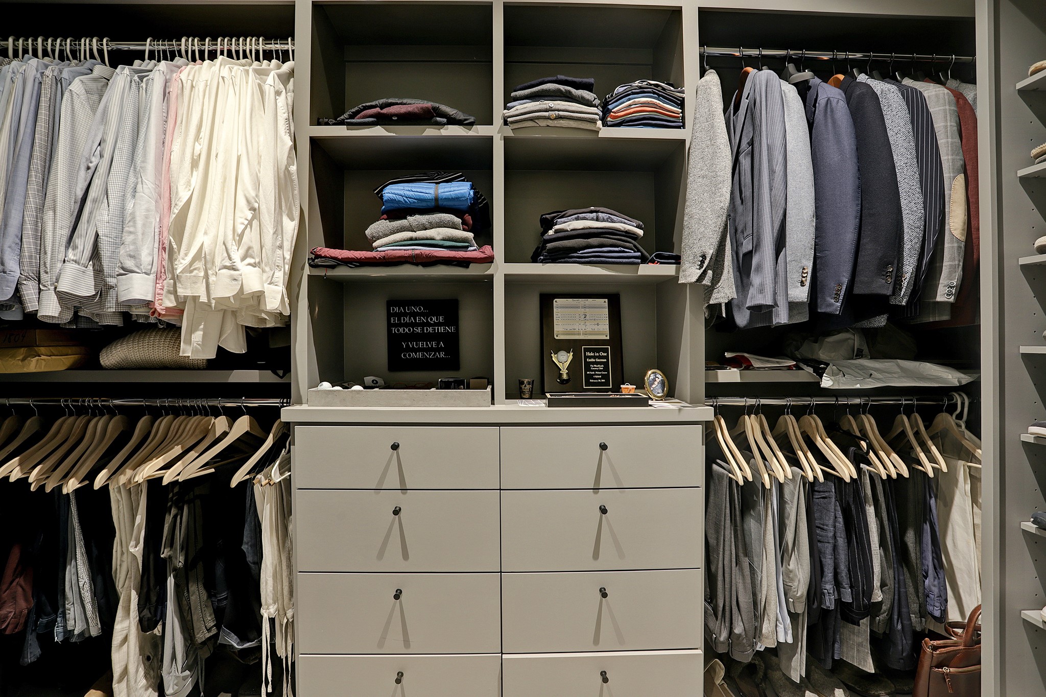 The CUSTOMIZED WALK-IN CLOSET has two built-in drawer systems, open shelving, shoe shelving, and ample clothes hanging space.