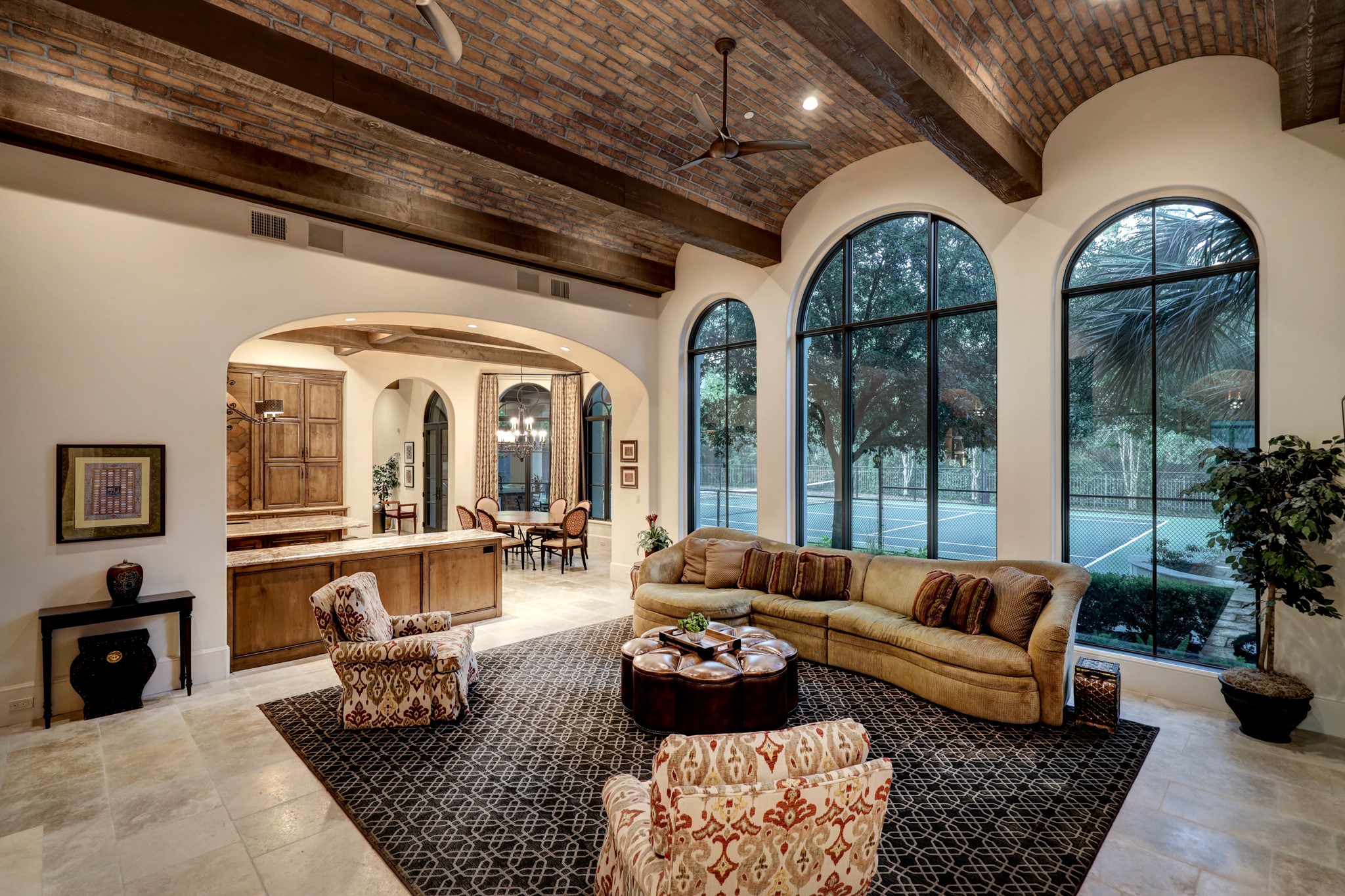 Family room open to kitchen with laid brick ceiling and bold wooden beams