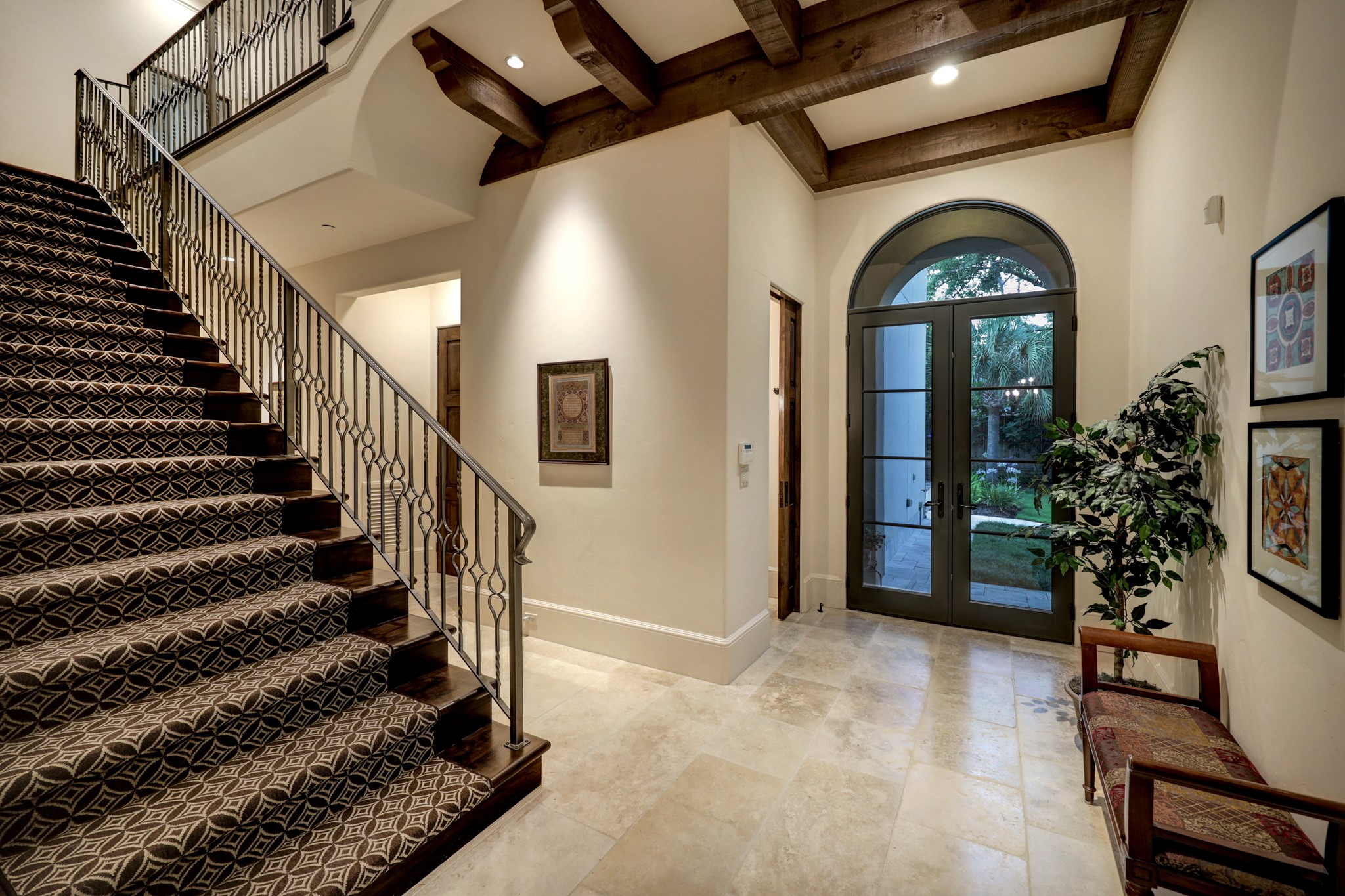 Second staircase with inlayed carpet leading to upstairs bedrooms, game room and theater