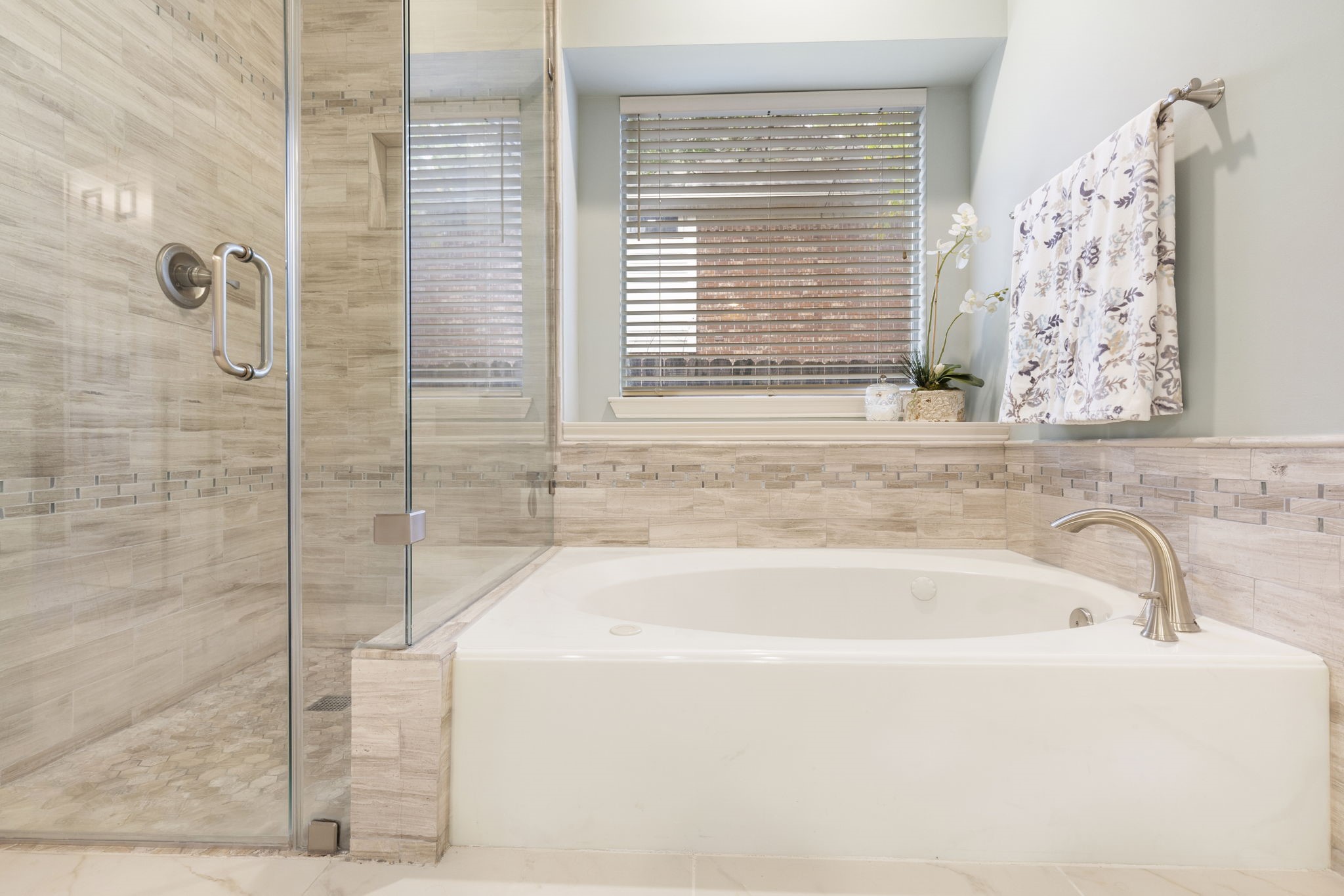 This tub and tile area is very inviting and  beautiful light spa colors