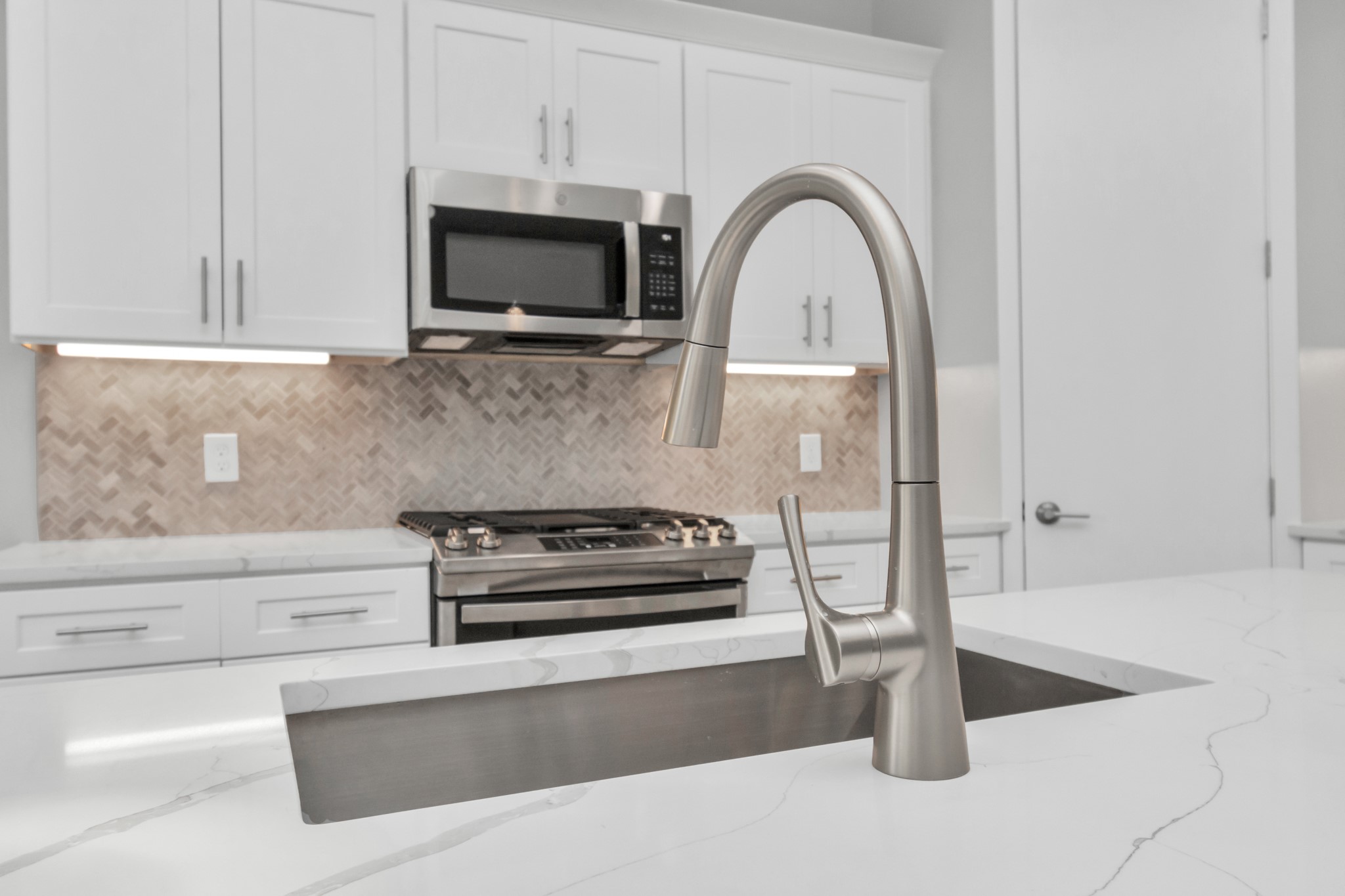 Brushed Nickel faucets blend perfectly with the Stainless Steel Appliances
