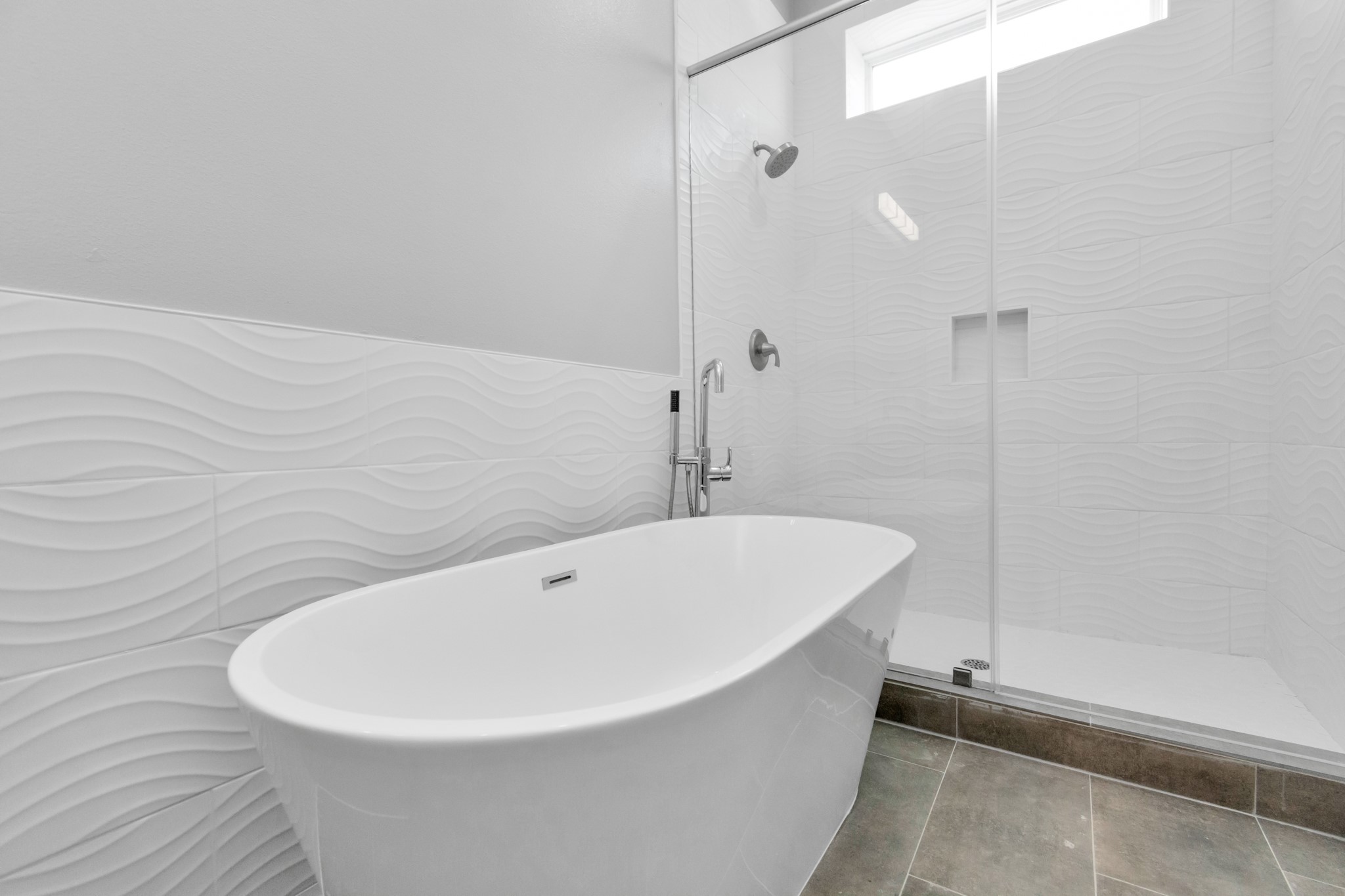 Large shower with stylish white tub surround