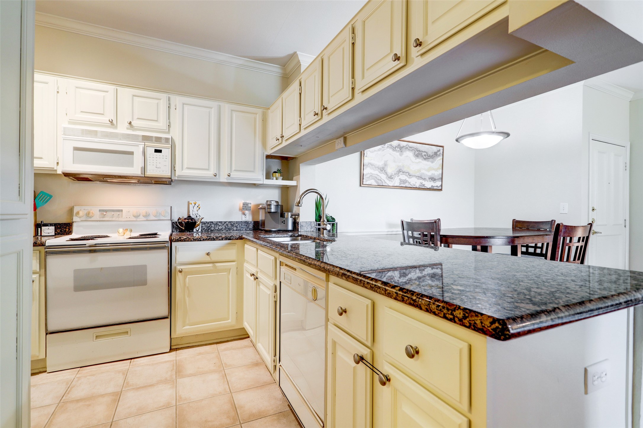Kitchen has lots of storage, granite counter tops with plenty of room to use as a buffet.