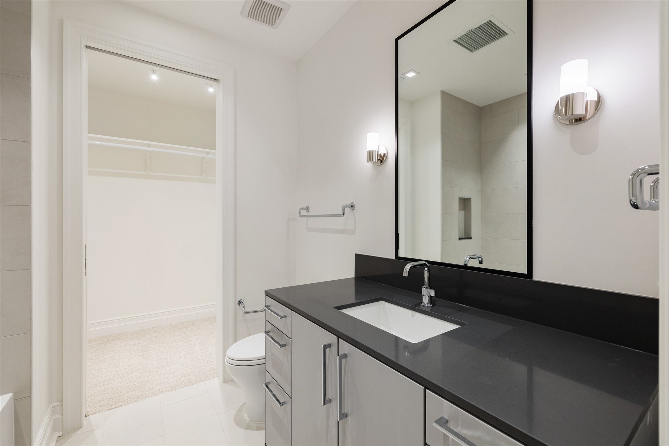 One of the Secondary En-suite Bathrooms features a Soaker Tub and Shower Combination with walk-in Closet.